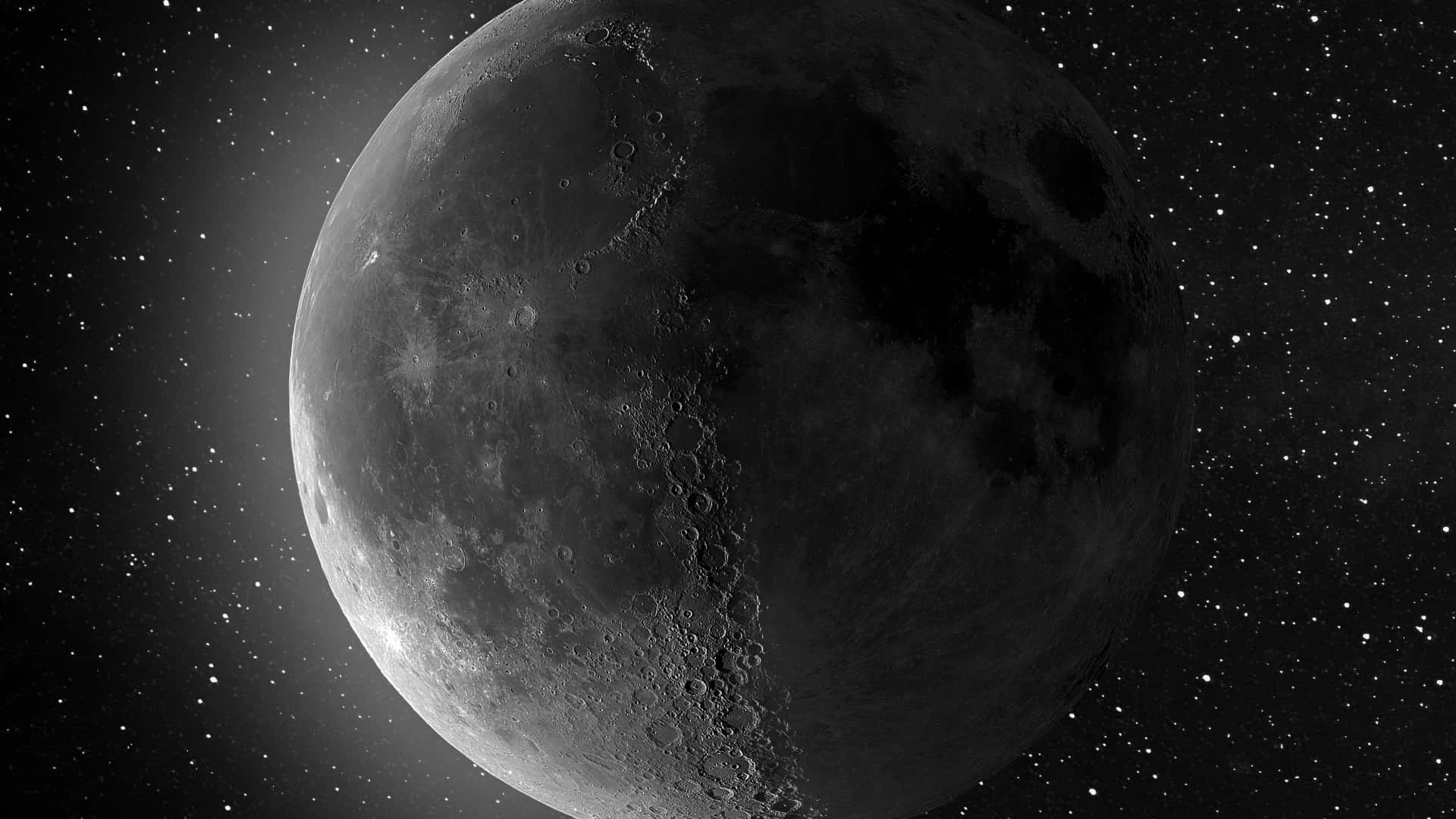 Black Space 桌布 壁紙 — 月球佈滿隕石坑的表面在深空星空中發光的單色視圖。