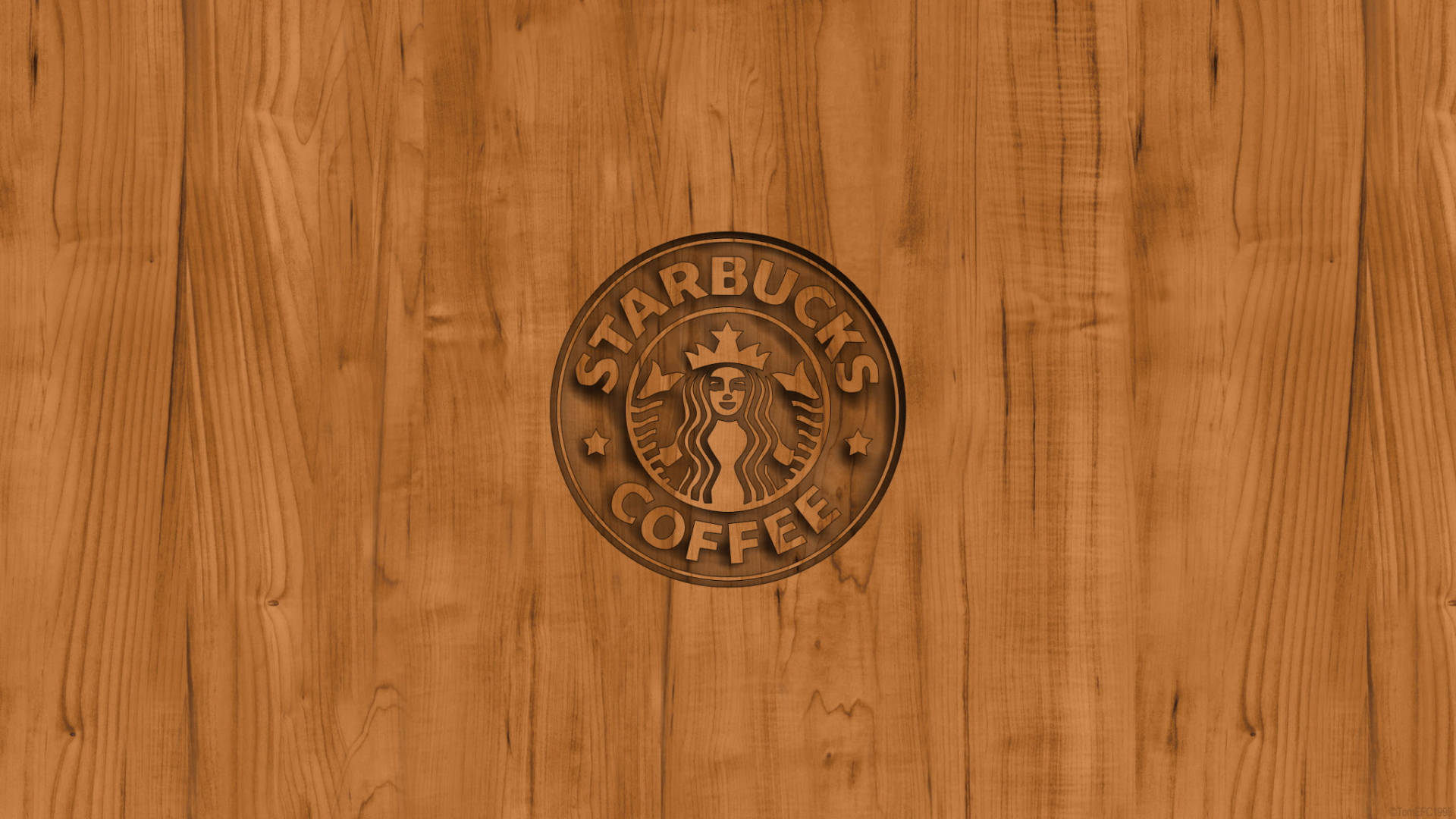 Starbucks 咖啡標誌雕刻在木質表面上。