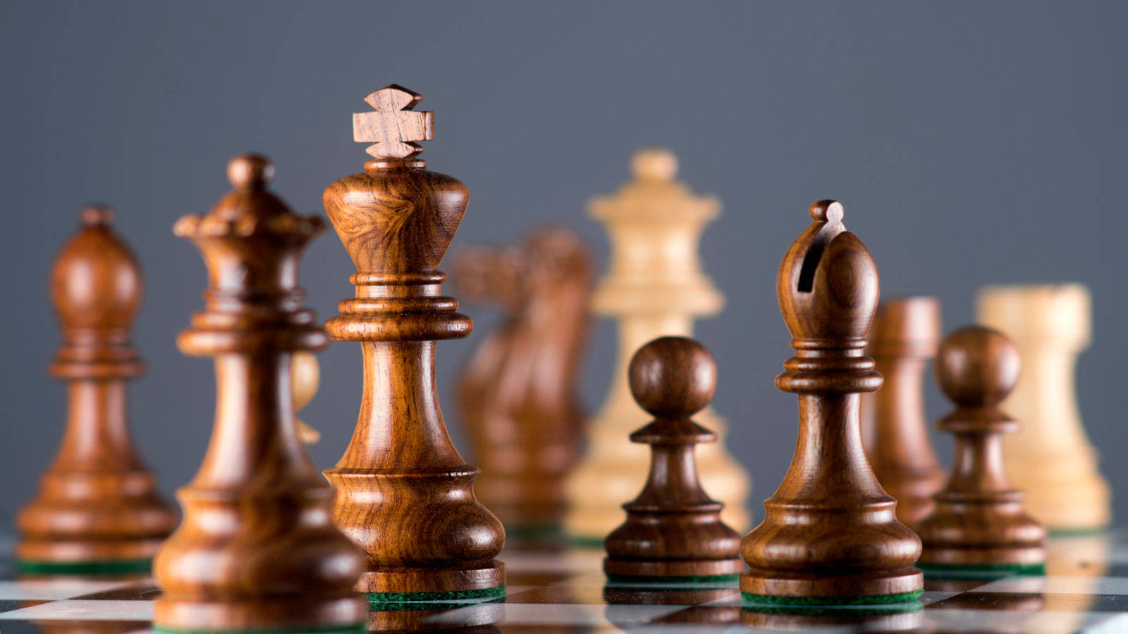 木製國際象棋棋子排列喺棋盤上，選擇性對焦。