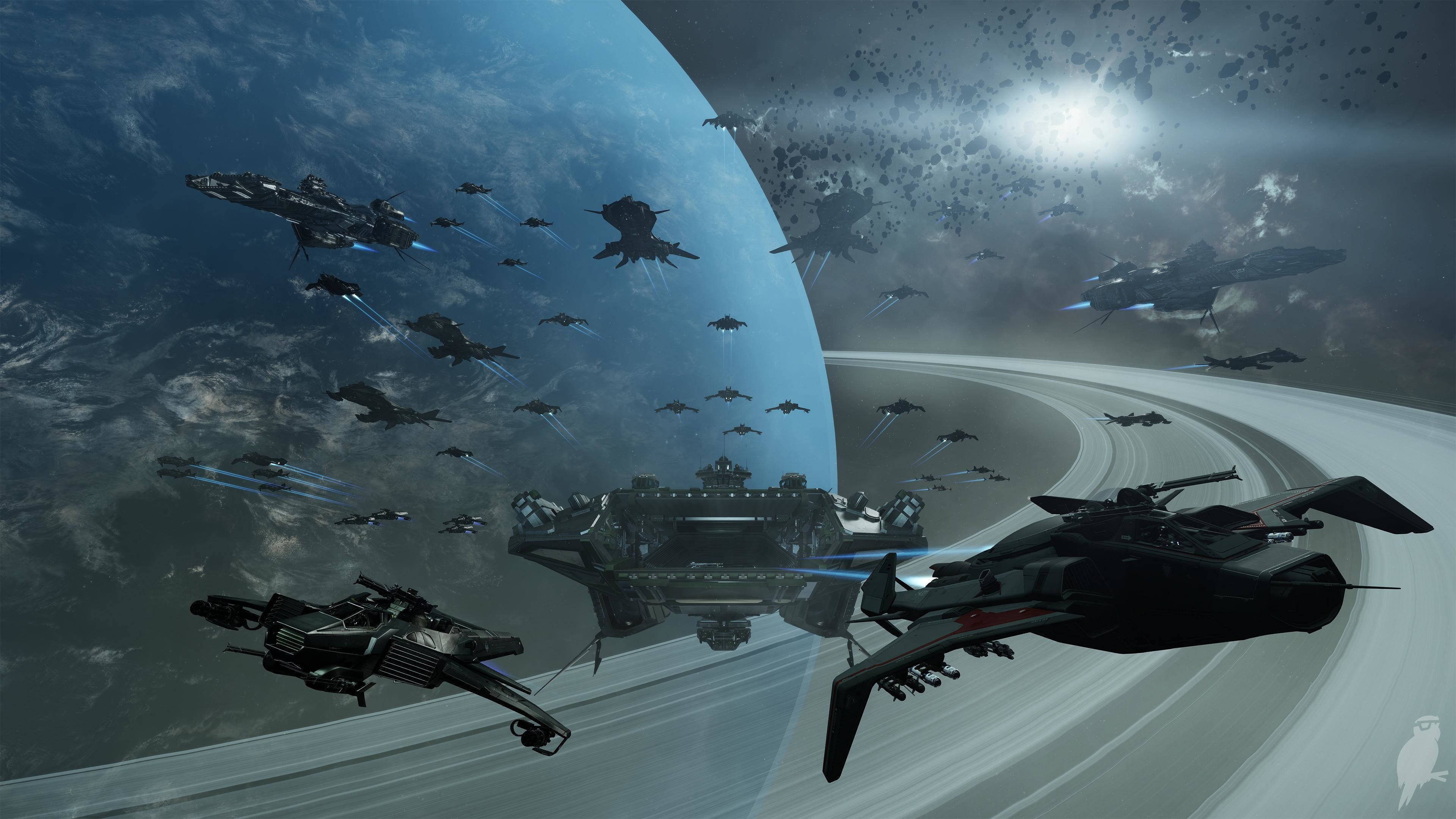 Star Citizen Spaceships Orbiting Saturn 壁紙 — 未來戰艦和戰鬥機在太空翱翔，靠近一個帶有光環的行星，明亮的太陽投射出戲劇性的光芒。