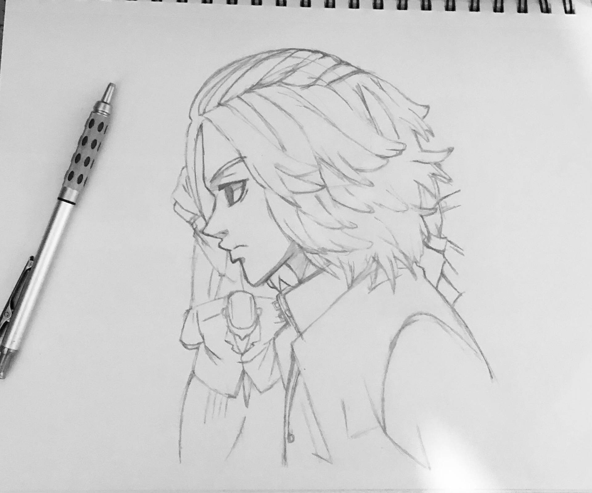 筆記本上的動漫角色素描及旁邊的筆