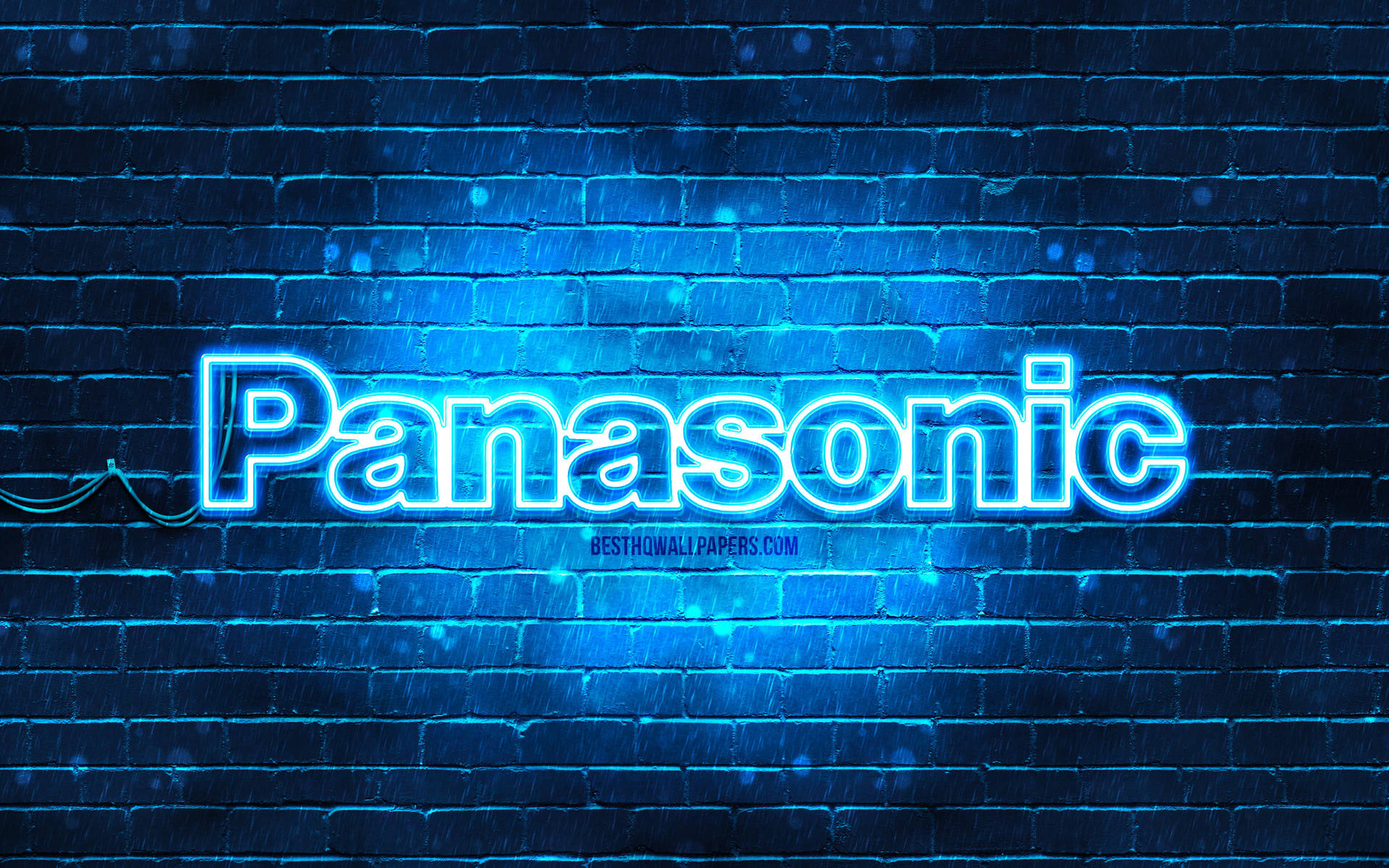 夜間潮濕磚牆上的藍色霓虹燈Panasonic標誌。