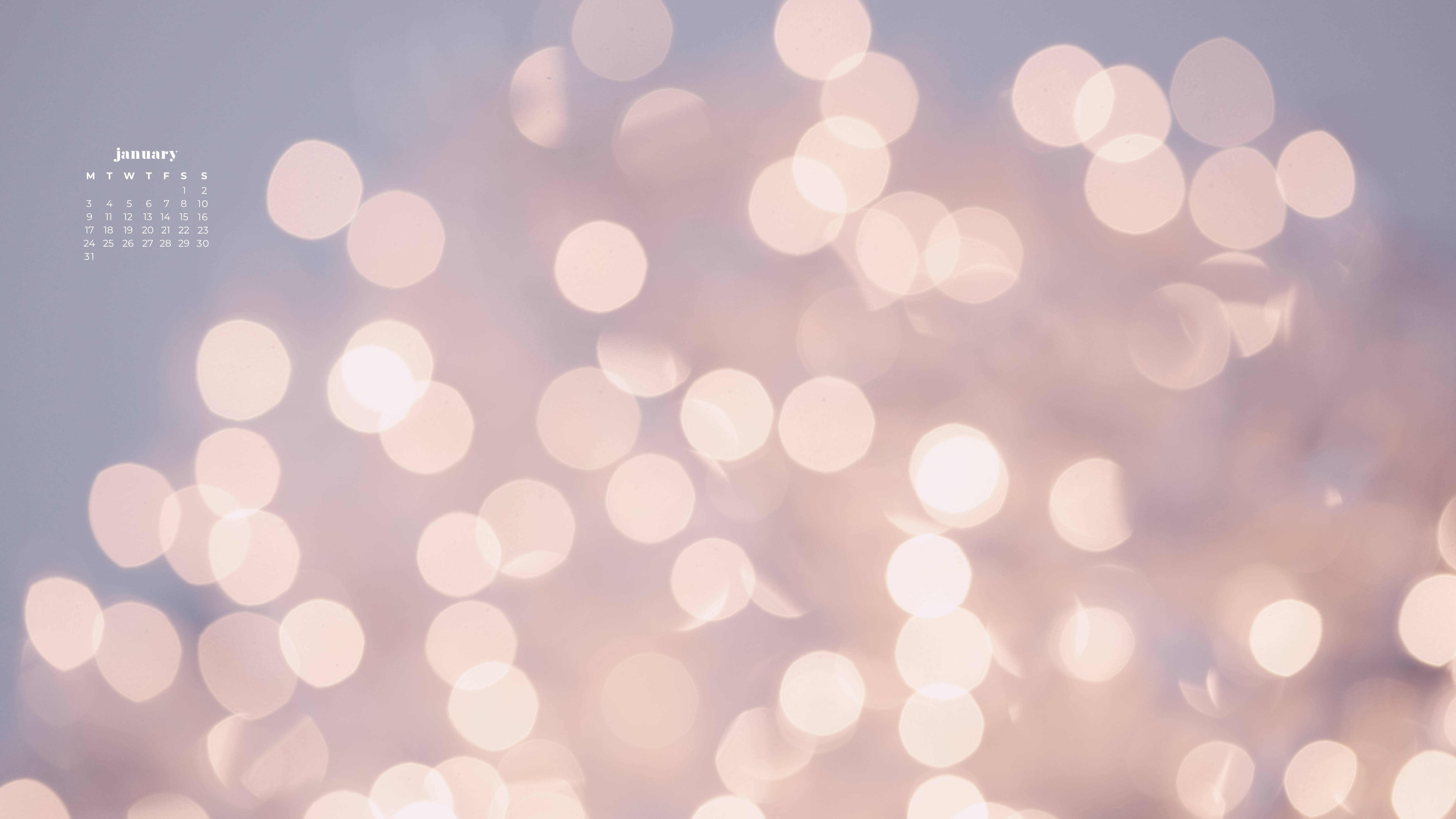 Bokeh 桌布 壁紙 — 柔和嘅粉彩散景燈光喺朦朧嘅天空下溫暖咁發光，角落有個低調嘅一月日曆。