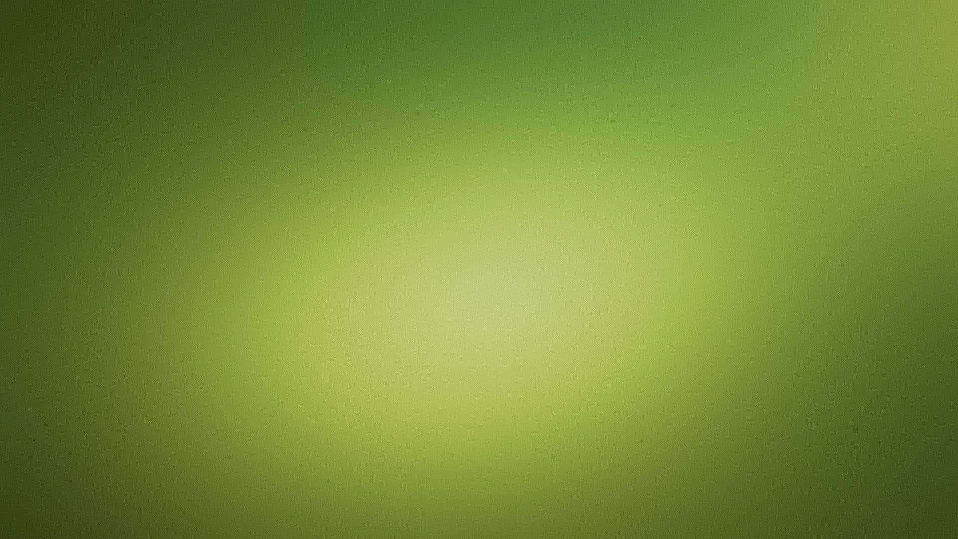Green Texture 桌布 壁紙 — 柔和的綠色色調漸變從明亮的中心向較暗的邊緣擴散，營造出平靜的抽象光芒。