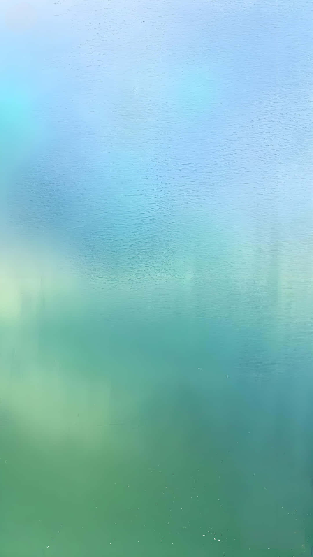 從藍色到綠色的平滑漸變，帶有輕柔的漣漪和柔和的光線反射