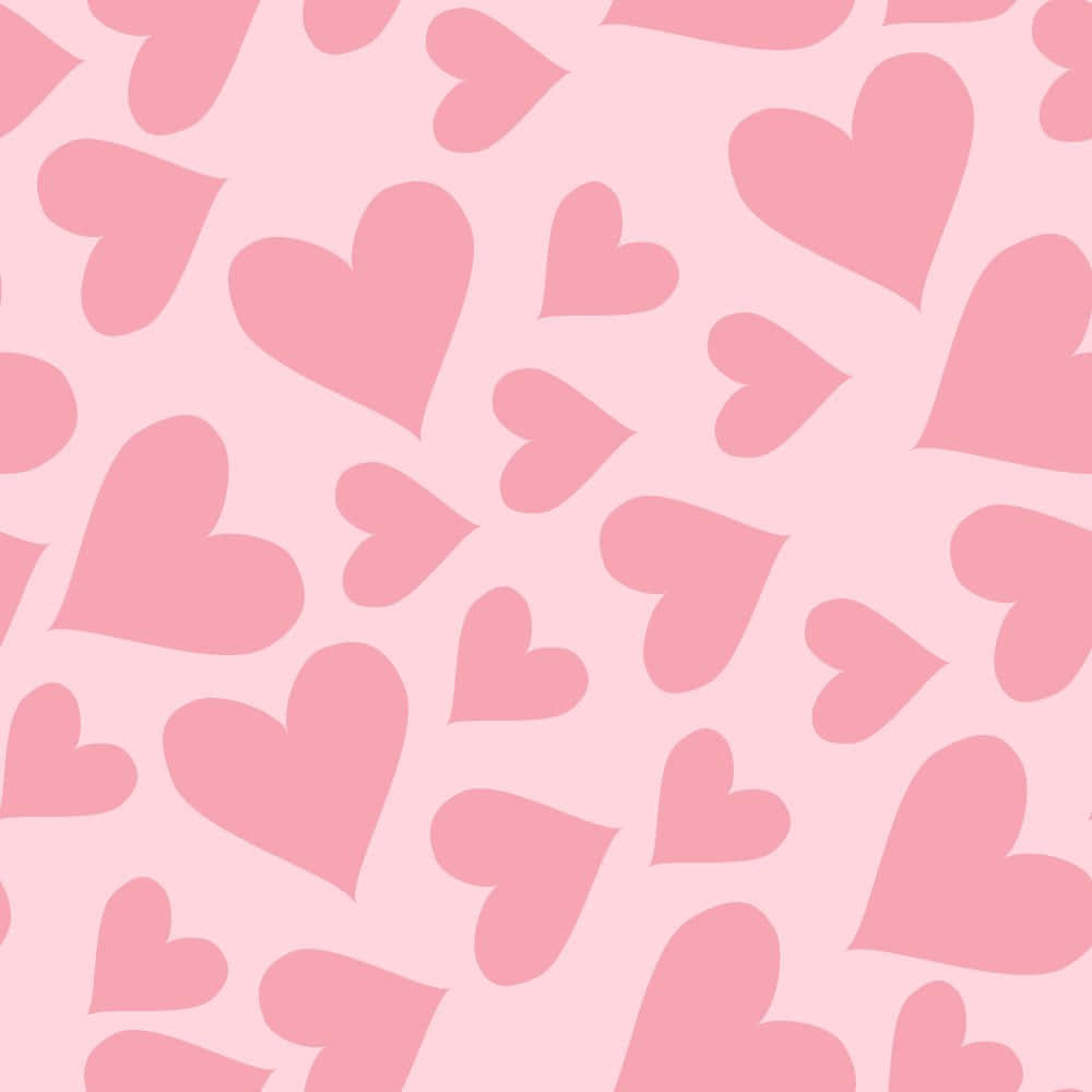 Heart Pattern 桌布 壁紙 — 柔軟的粉紅色牆紙圖案，散落著不同大小和方向的心形。