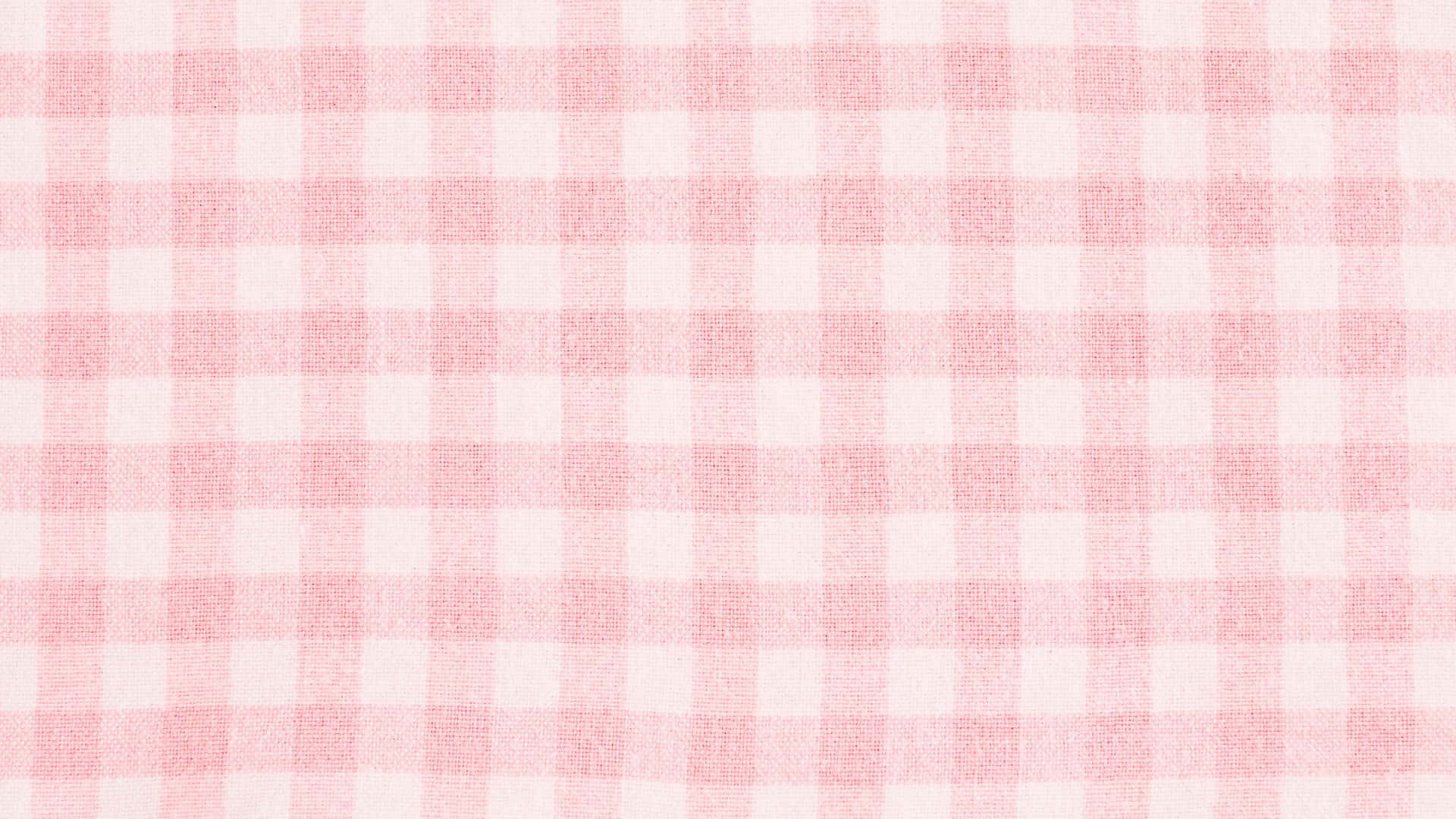 Pink Checkered 桌布 壁紙 — 柔軟粉紅白色格仔布料的特寫，可見編織紋理和均勻的網格圖案。