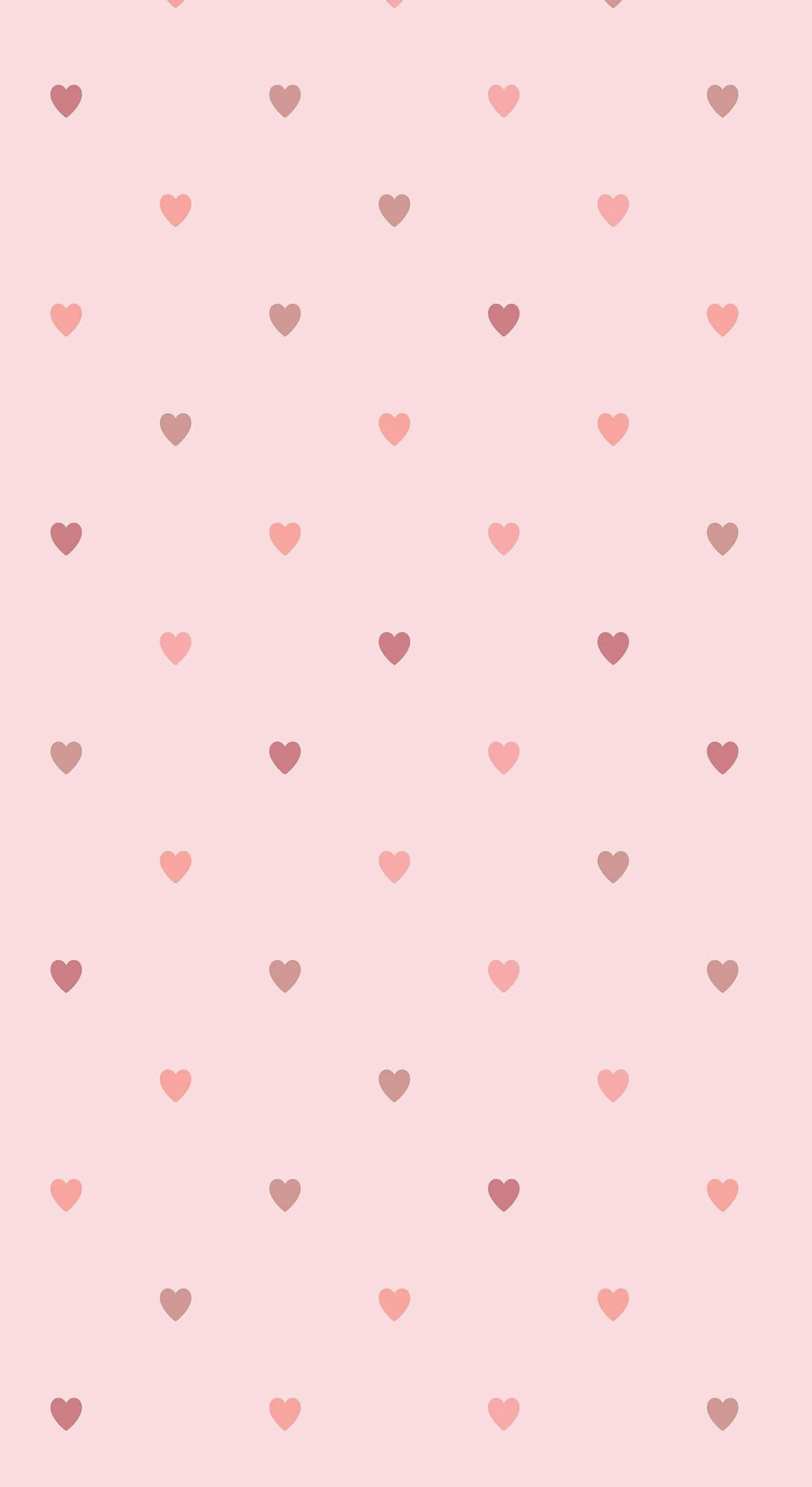Cute Hearts 桌布 壁紙 — 柔軟粉紅背景點綴著散落的粉彩心形，呈現玫瑰色與紫紅色的不同色調。