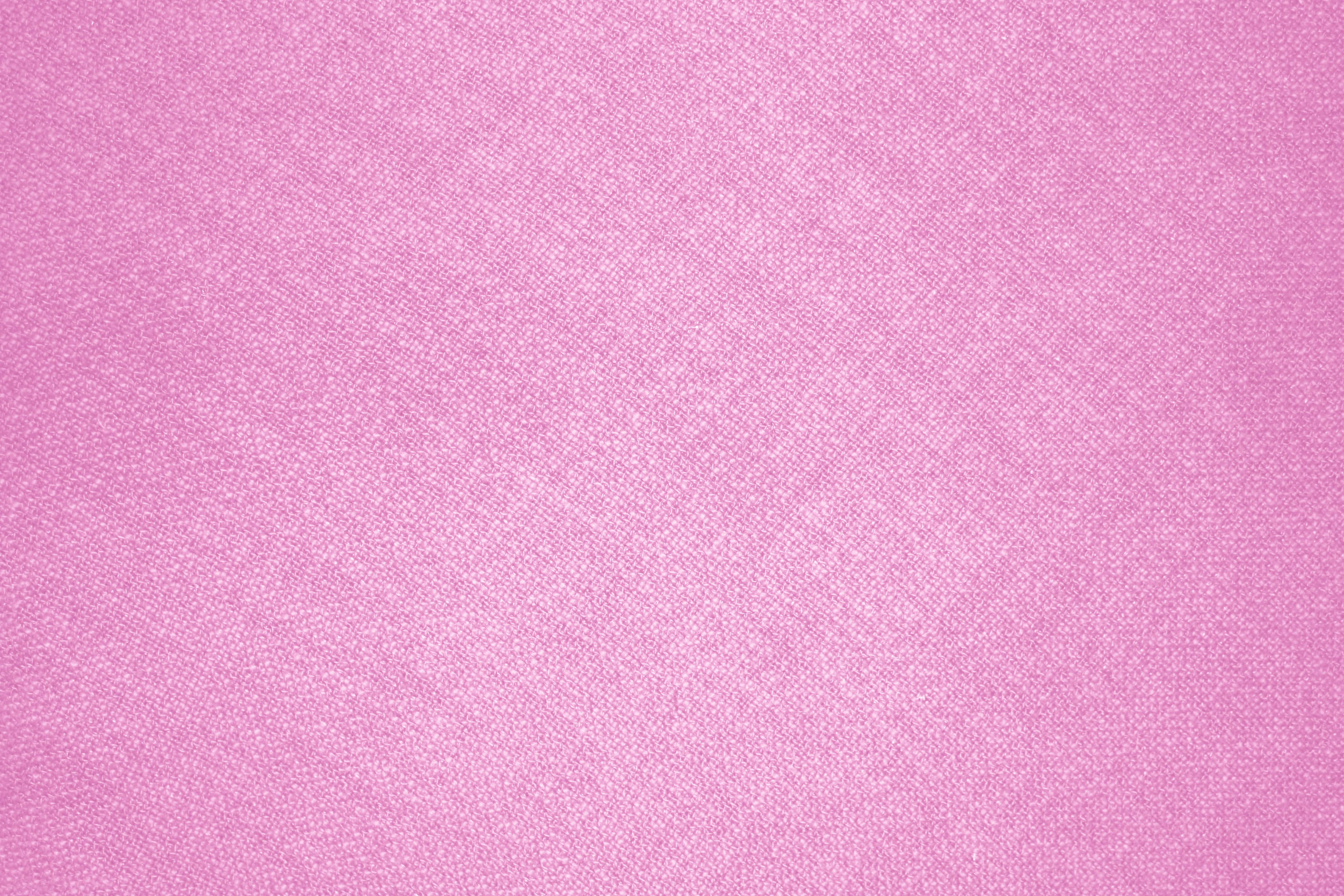 Pink Texture 桌布 壁紙 — 柔軟粉紅色紋理布料的特寫，帶有細膩的編織圖案和柔和漸變。