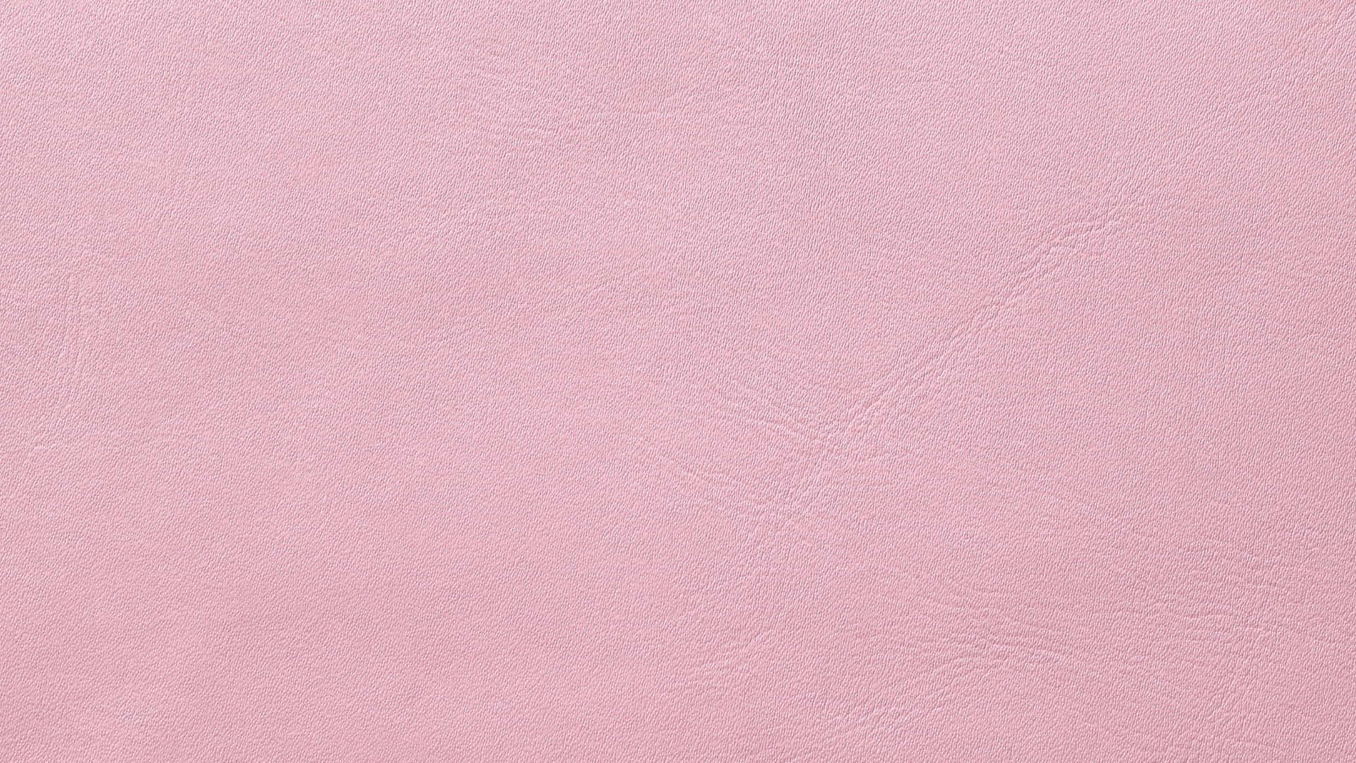 Pink Texture 桌布 壁紙 — 柔軟粉紅色紋理皮革的特寫，帶有微妙的自然皺褶和光滑的啞光飾面。