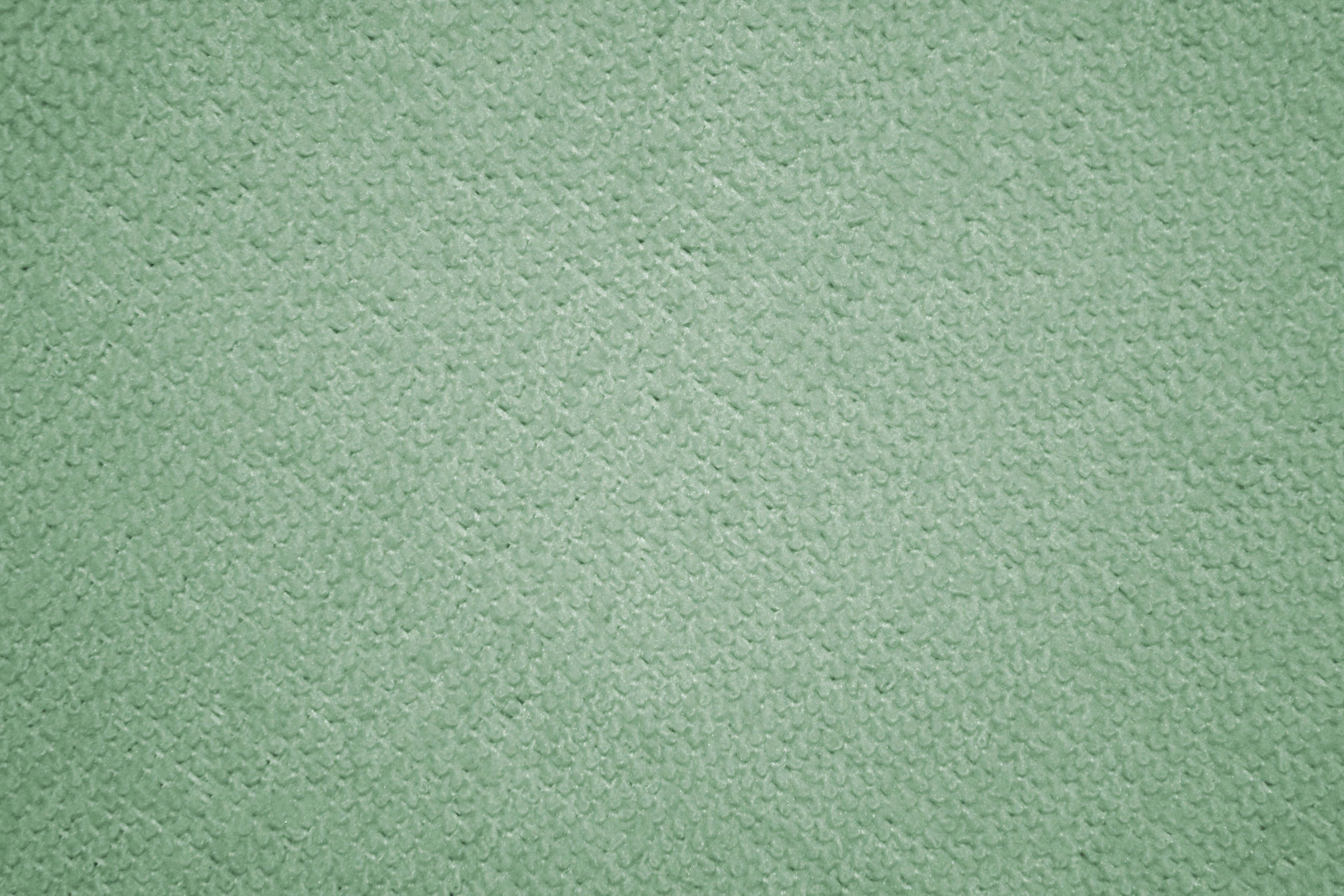 sage green aesthetic 桌布 壁紙 — 柔軟薄荷綠色紋理布料的特寫，帶有均勻的編織圖案。
