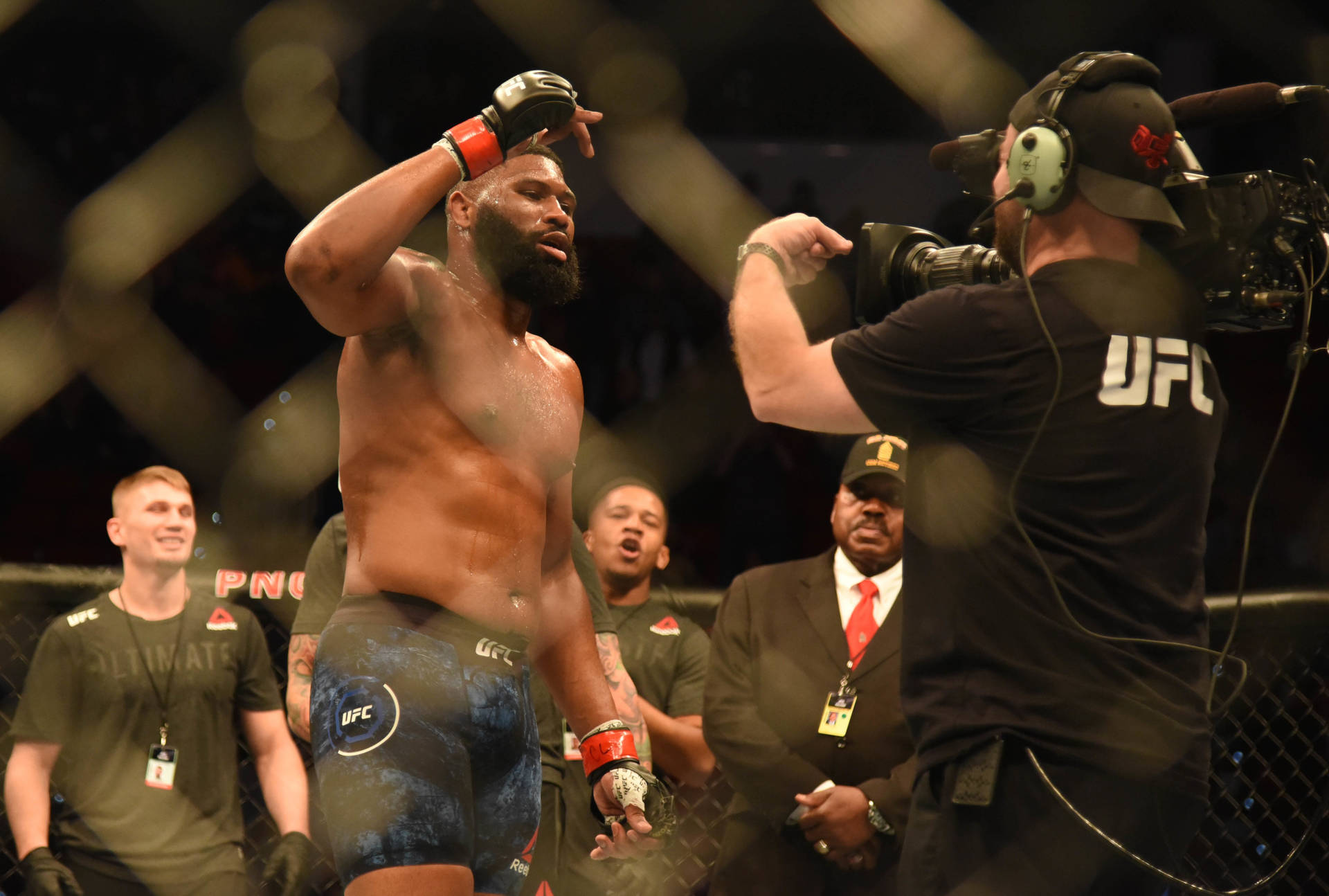 UFC拳手在八角籠內與攝製組慶祝勝利。