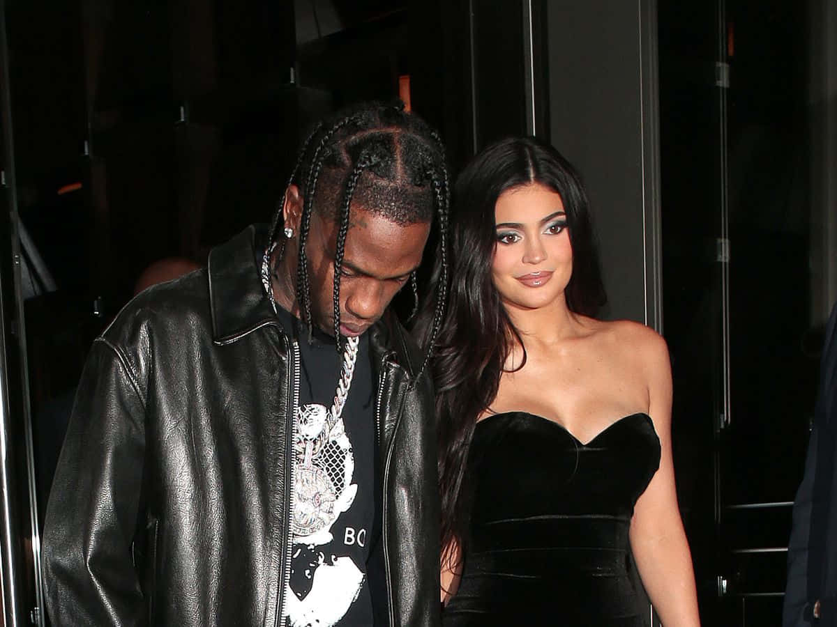 Travis Scott 和 Kylie Jenner 在夜晚穿著黑色皮革和天鵝絨服裝一起散步。
