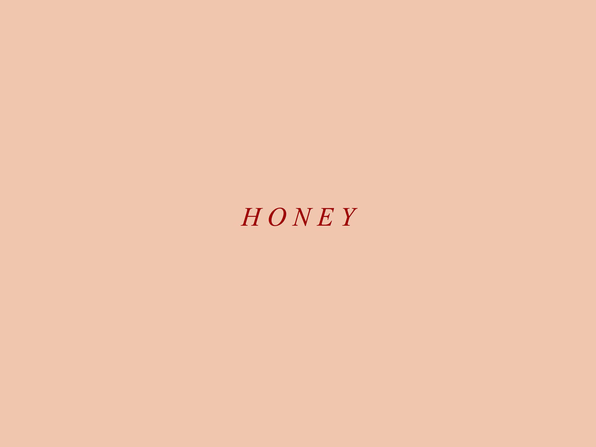 桃色美學蜂蜜 壁紙 — 單詞 honey 以紅色襯線字體居中顯示在純色蜜桃色背景上。