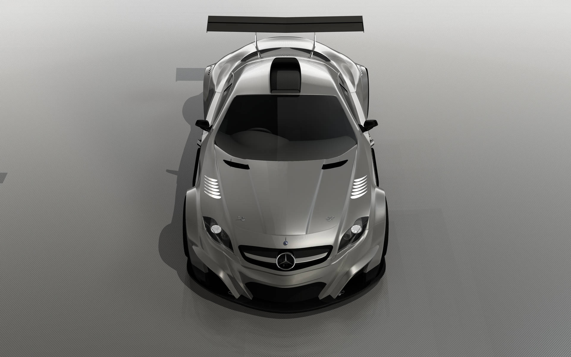 在工作室環境中銀色 Mercedes-AMG GT 賽車的俯視圖。