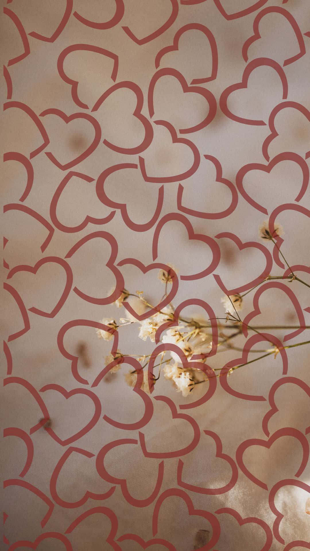 紋理背景上的粉紅色心形圖案搭配白色乾花。