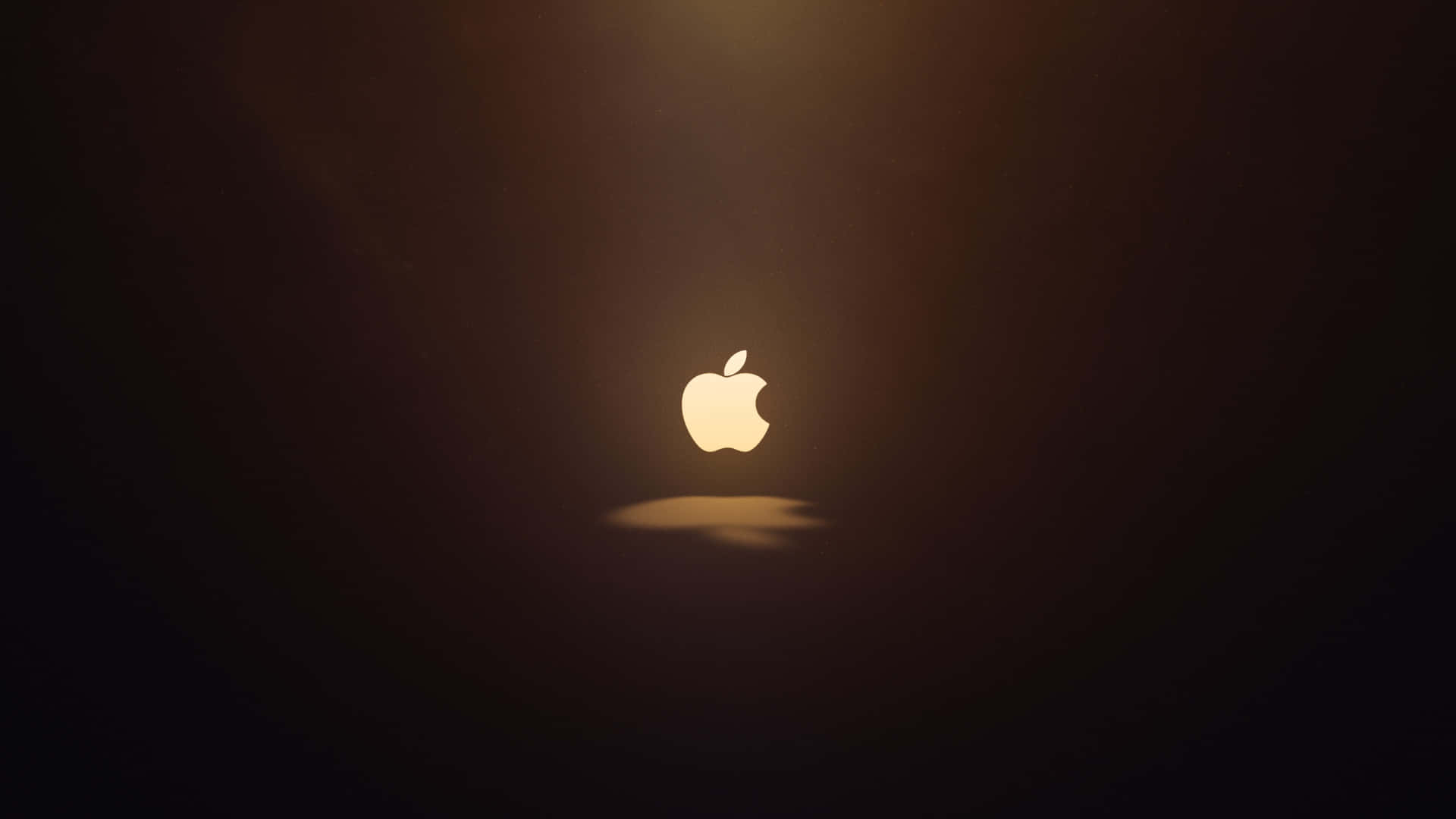 發光的Apple標誌置於深色背景中央，帶有金色光芒和陰影。