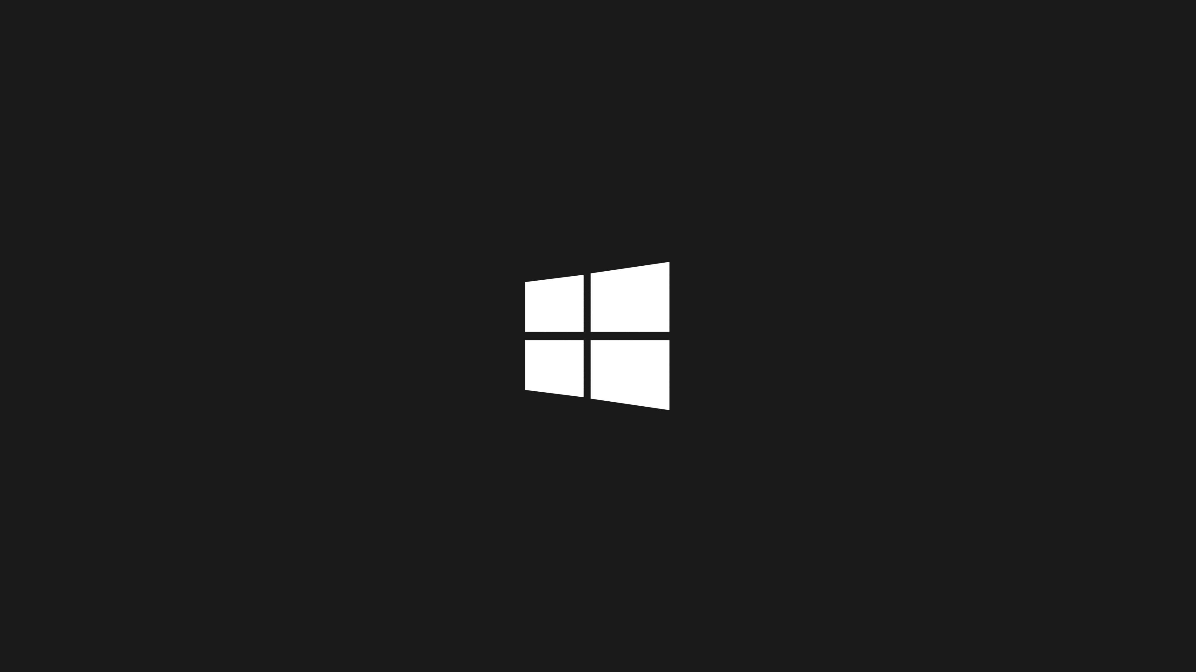 極簡主義 Windows 10 高畫質白色標誌 壁紙 — 一個極簡的白色Windows標誌居中在純黑色背景上。