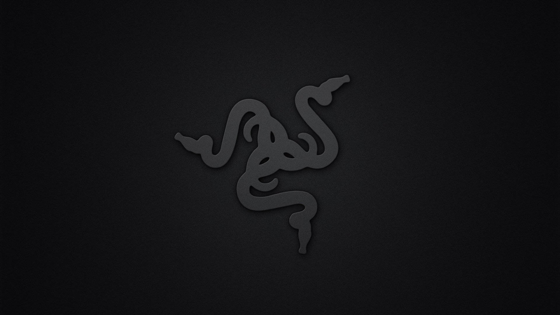 極簡深色 Razer PC 標誌 壁紙 — 一個極簡的深灰色 Razer 標誌，微妙地壓印在帶有紋理的黑色背景上。
