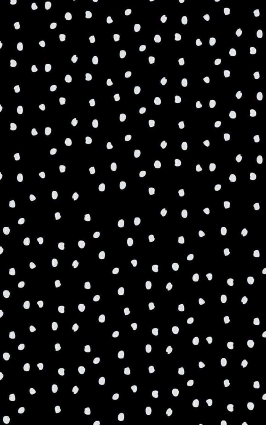 Black And White Dots 桌布 壁紙 — 極簡黑色背景，點綴著分散的白色筆觸點，形成大膽的圖形圖案。