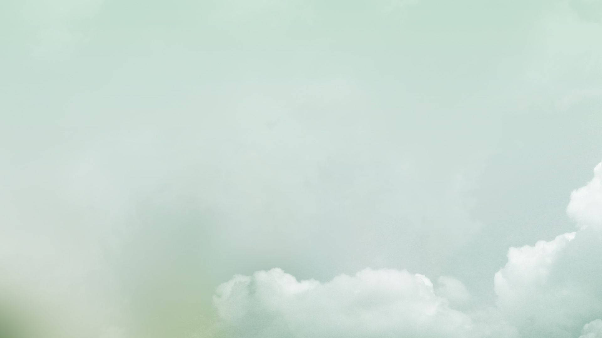 粉綠色天空，柔和白色雲朵平靜飄動。