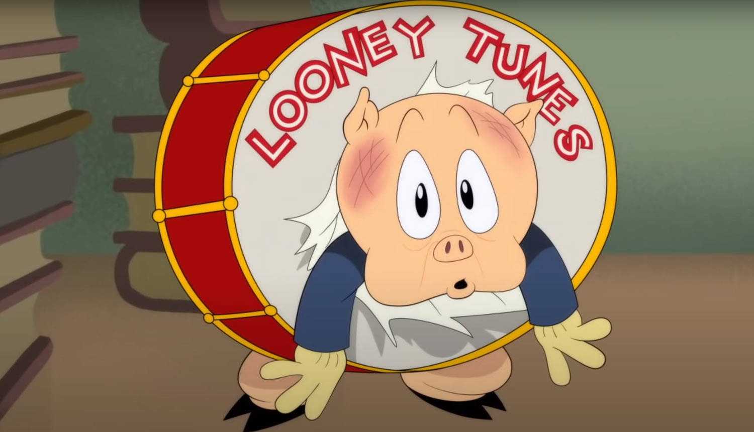 Porky Pig 睜大眼睛從 Looney Tunes 鼓後面探出頭來。