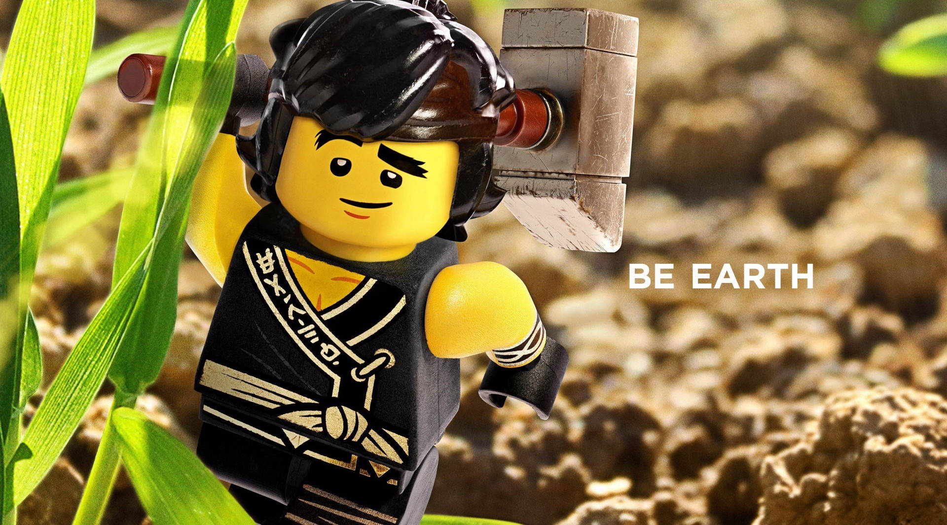 LEGO 大地忍者在草地上手持石錘，附有「BE EARTH」文字。
