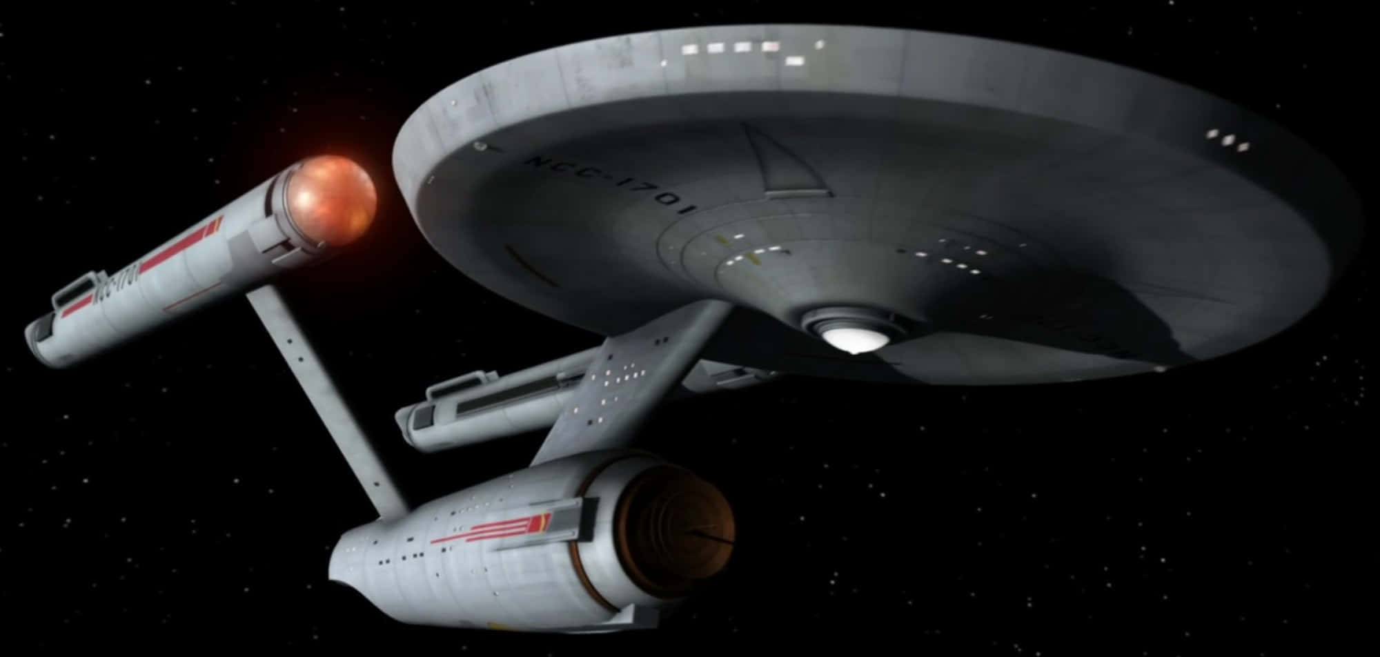 太空船 桌布 壁紙 — 標誌性的星艦企業號NCC-1701在繁星點點的太空中滑行，配備發光的曲速艙和詳細的碟形部分。