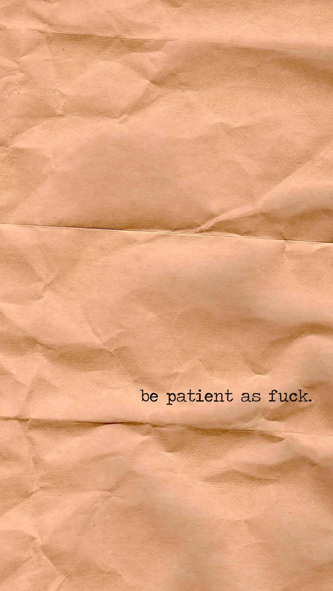 皺巴巴的棕色紙張，上面印有黑色短語 be patient as fuck。