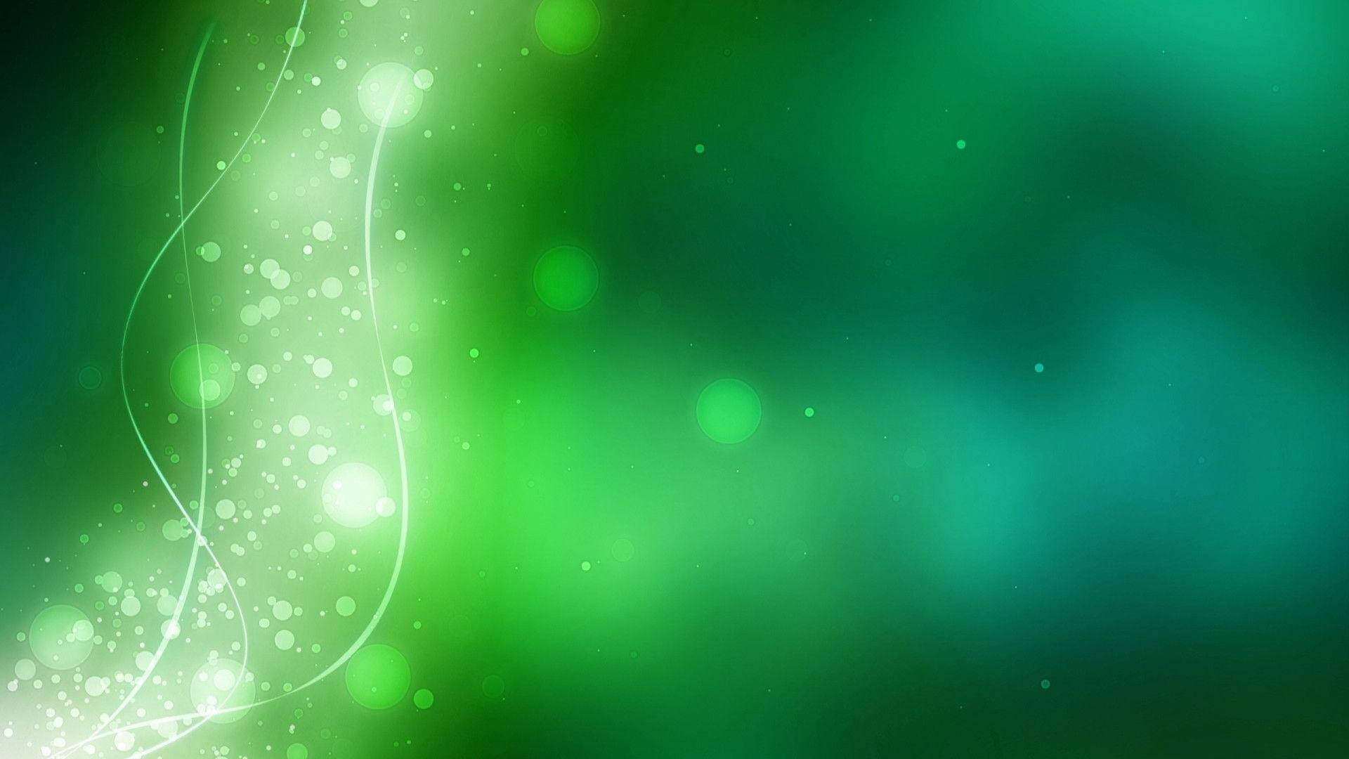 發光的綠色抽象背景，帶有旋轉的光效和散景。