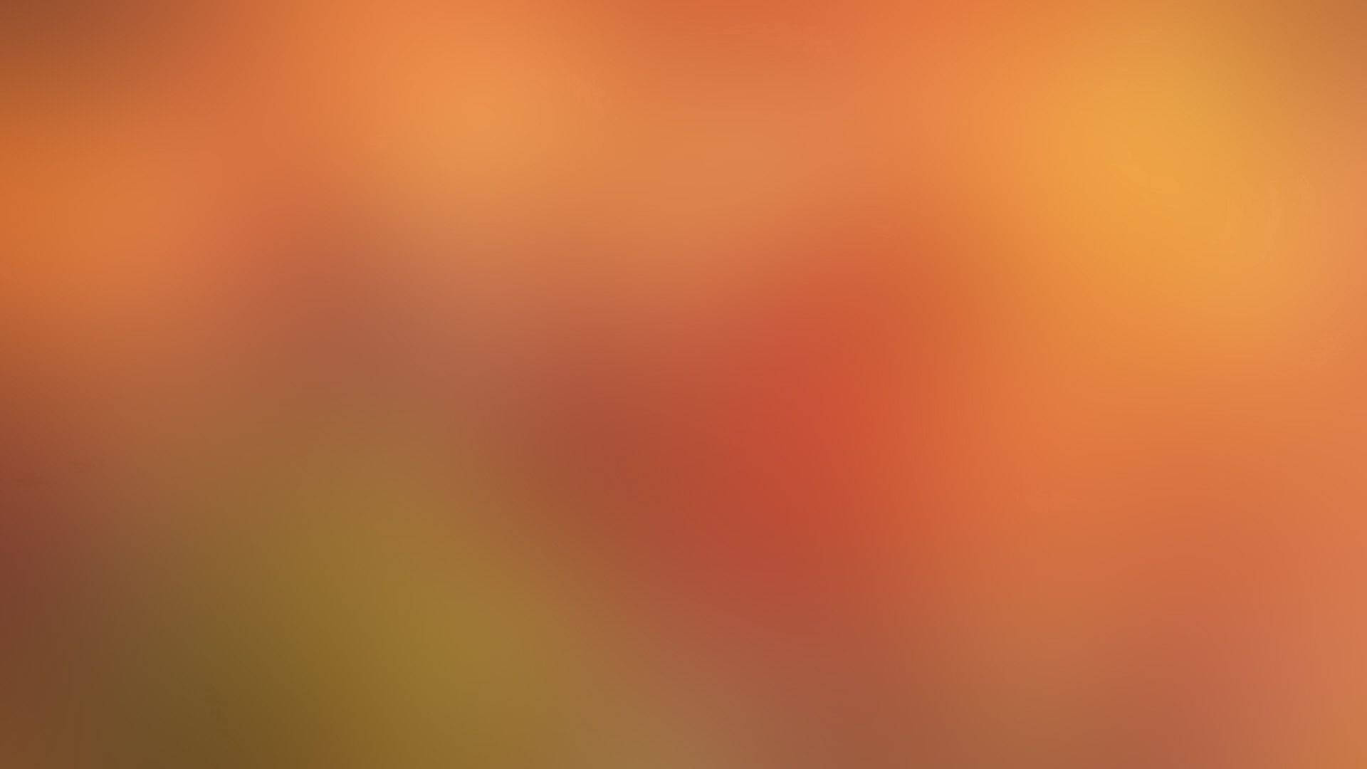 暖橙紅和黃色調的柔和抽象漸變。