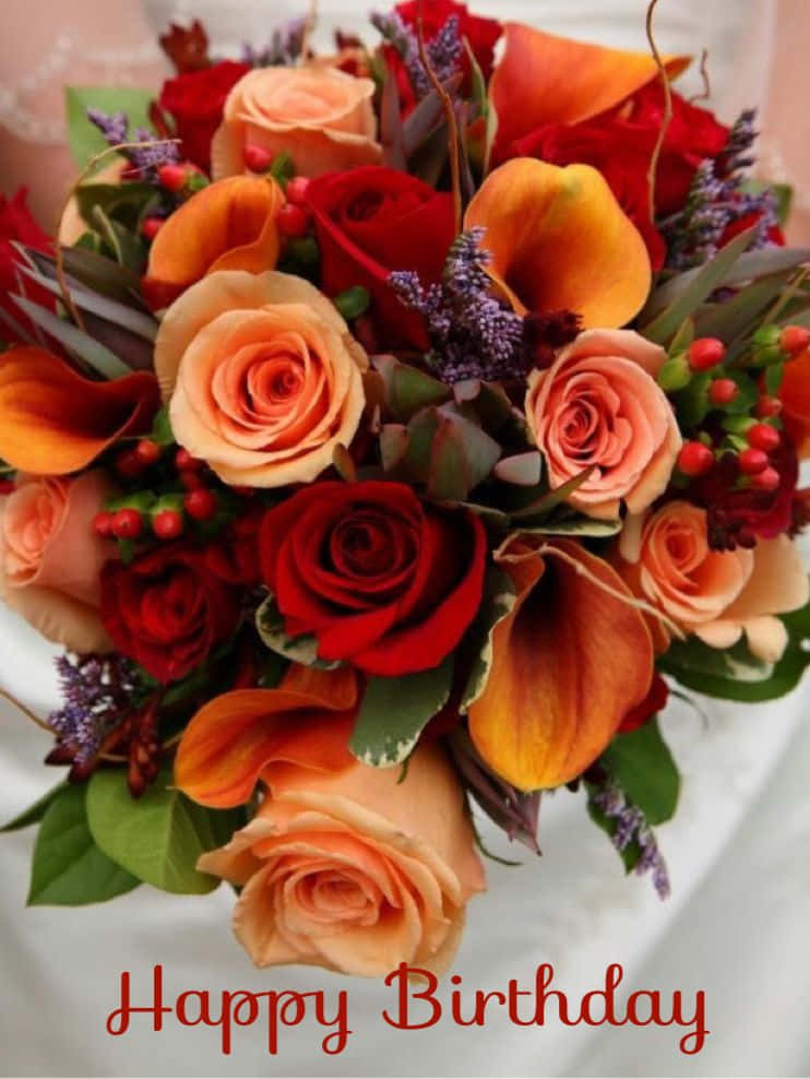 生日花束，包含紅色、蜜桃色和橙色花朵以及紫色漿果。