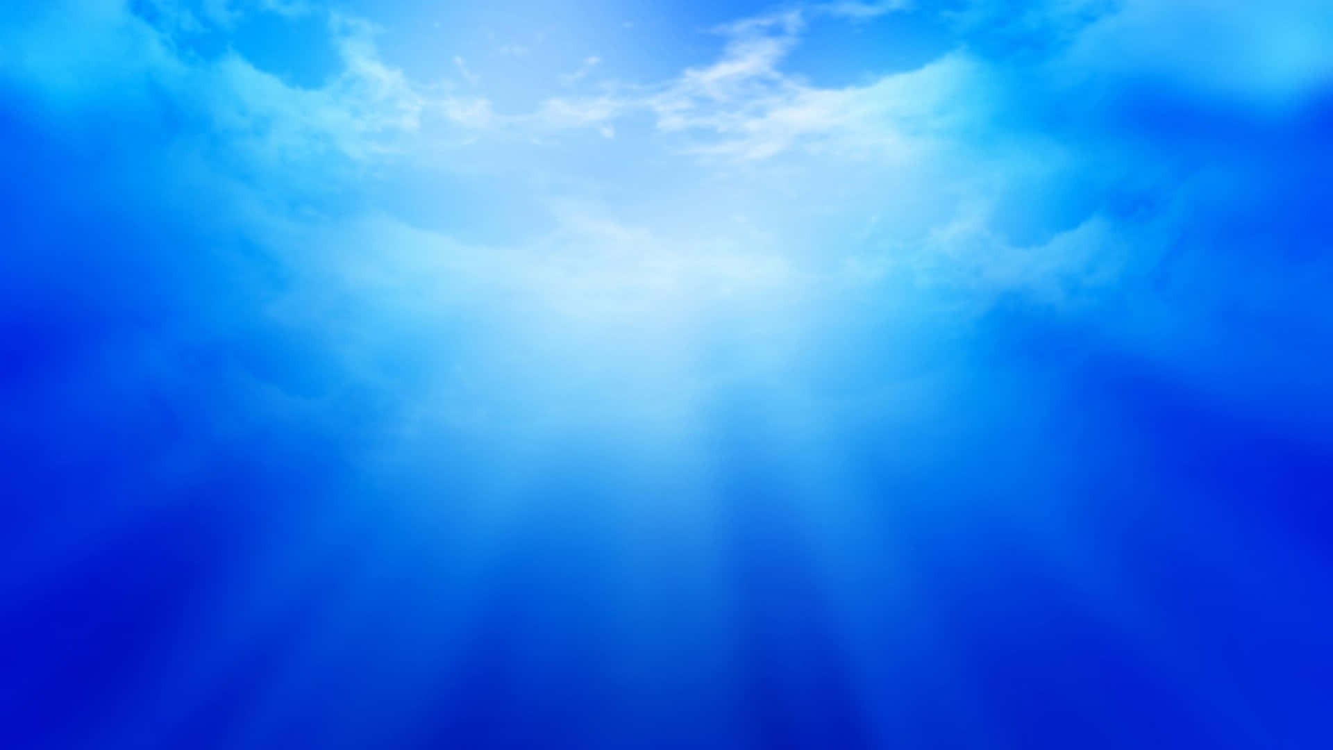 晴朗的日子裡，陽光穿過藍天和白雲。