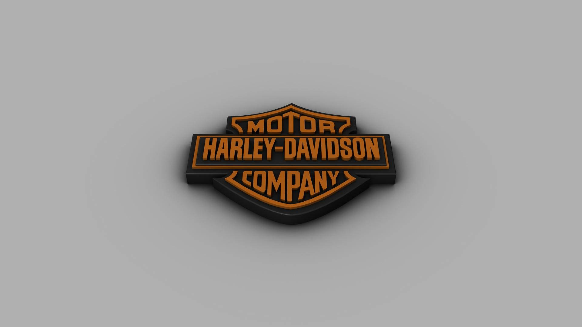 橡膠質感哈雷戴維森標誌 壁紙 — 一個3D渲染的Harley-Davidson標誌，灰色背景上帶有橙色和黑色字體。