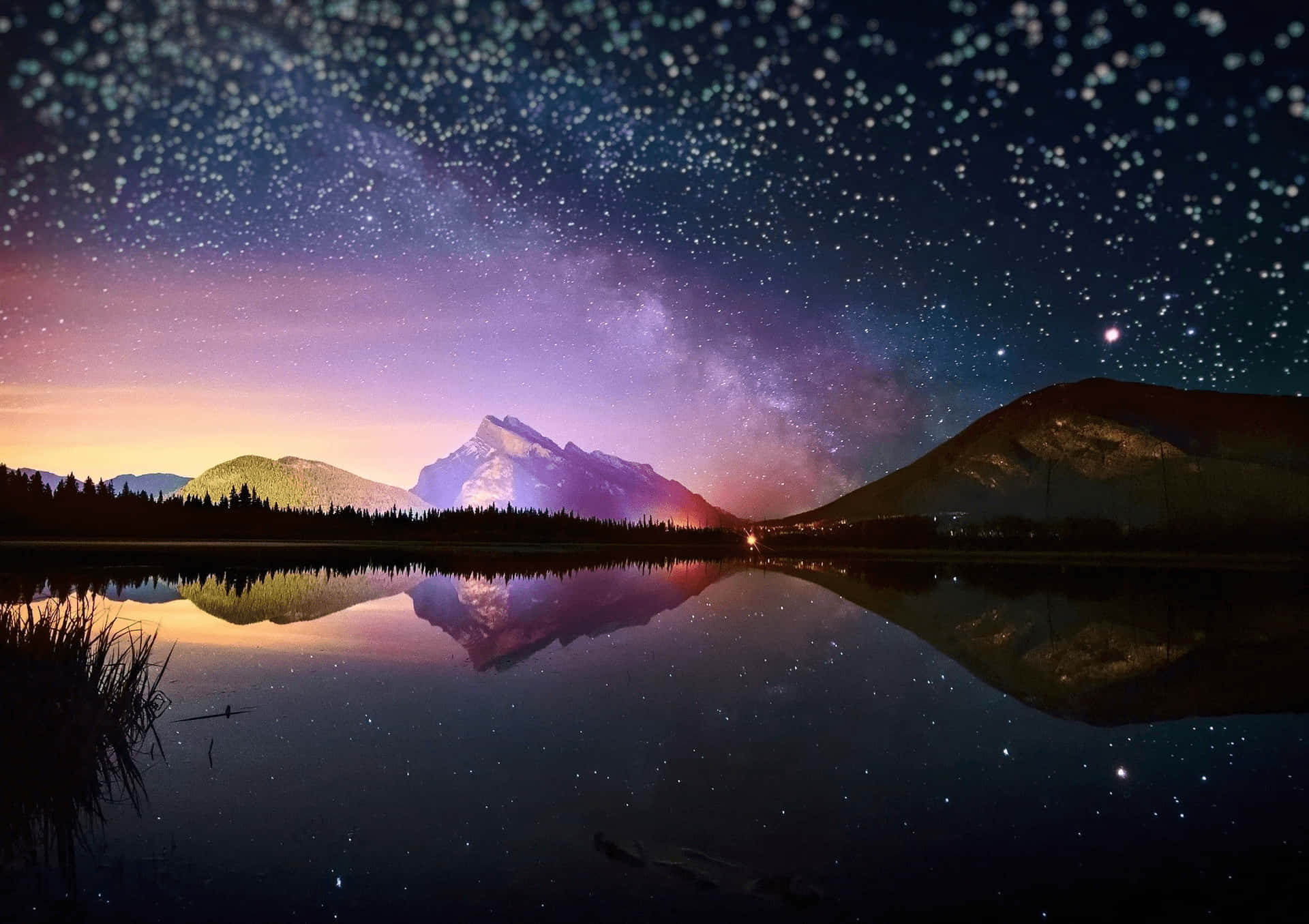 繁星點點的夜空，銀河倒映在山間湖泊中。