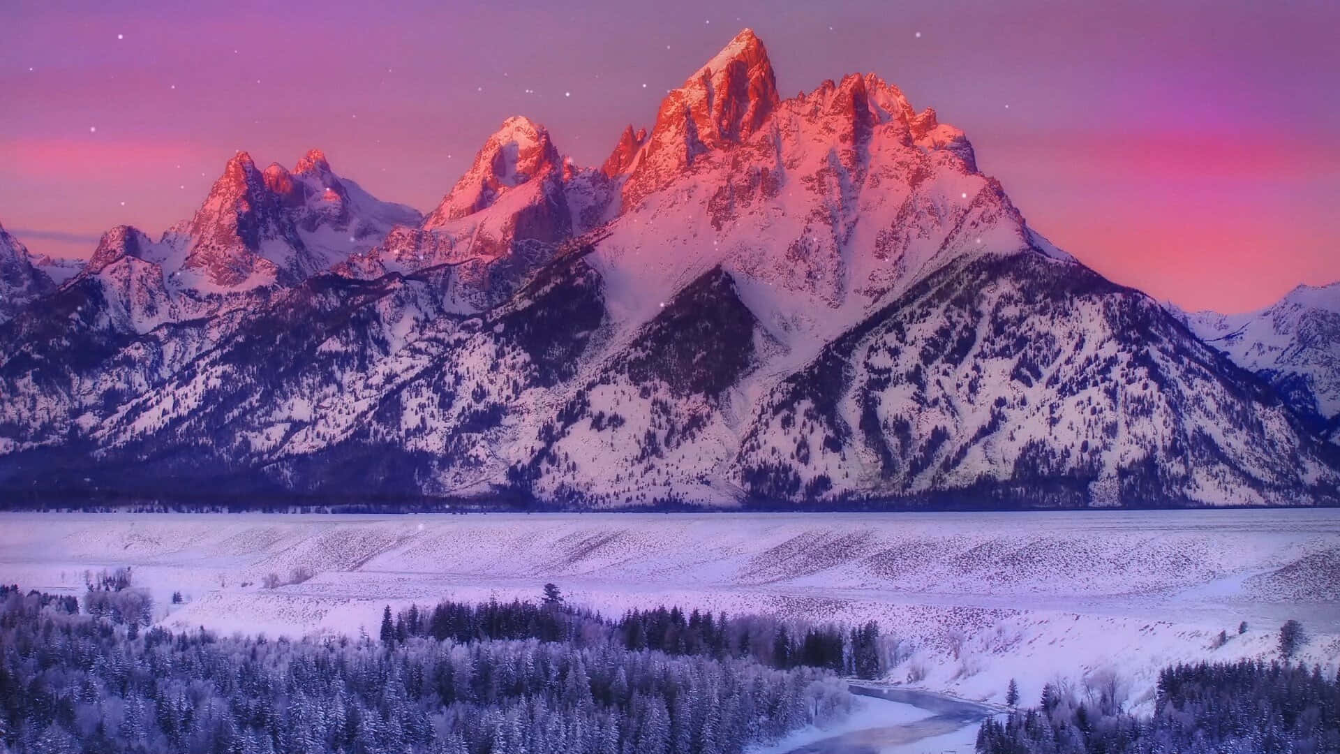 欣賞大自然的壯麗山景 壁紙 — 白雪覆蓋的山峰在冰封山谷上方的星空暮色下閃耀著粉紅色和紫色。