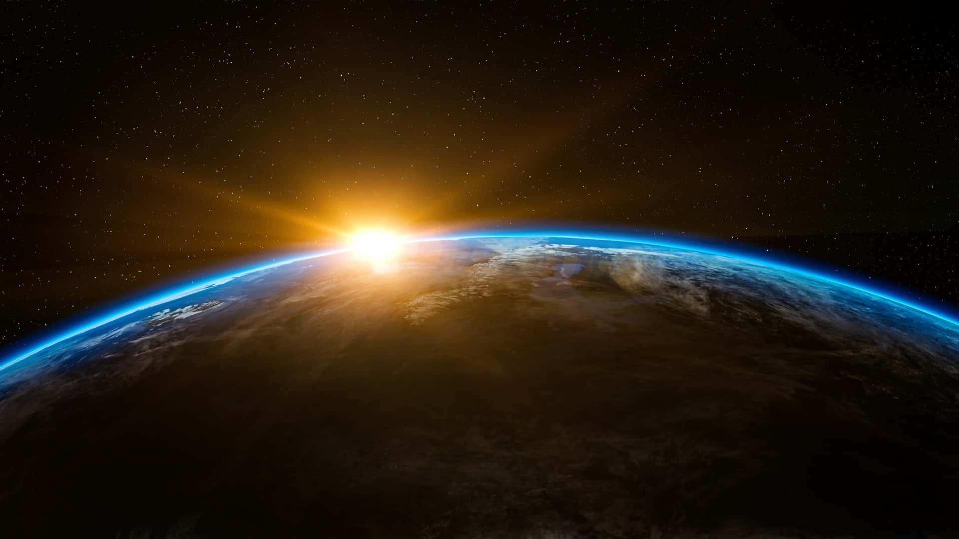 太陽從地球彎曲的地平線升起，藍色大氣和星空。