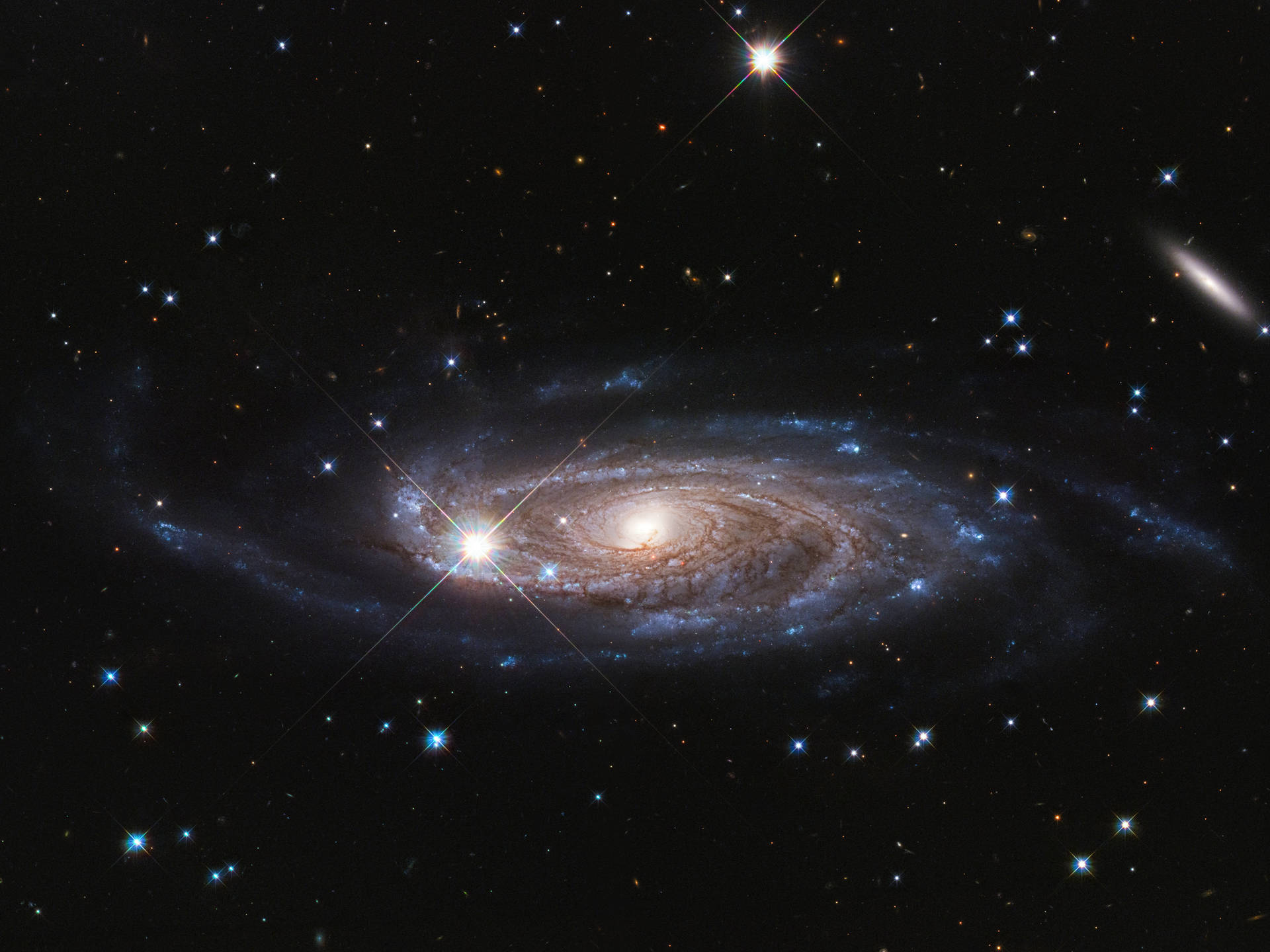一個在深空中帶有明亮星星和發光旋臂的螺旋星系。