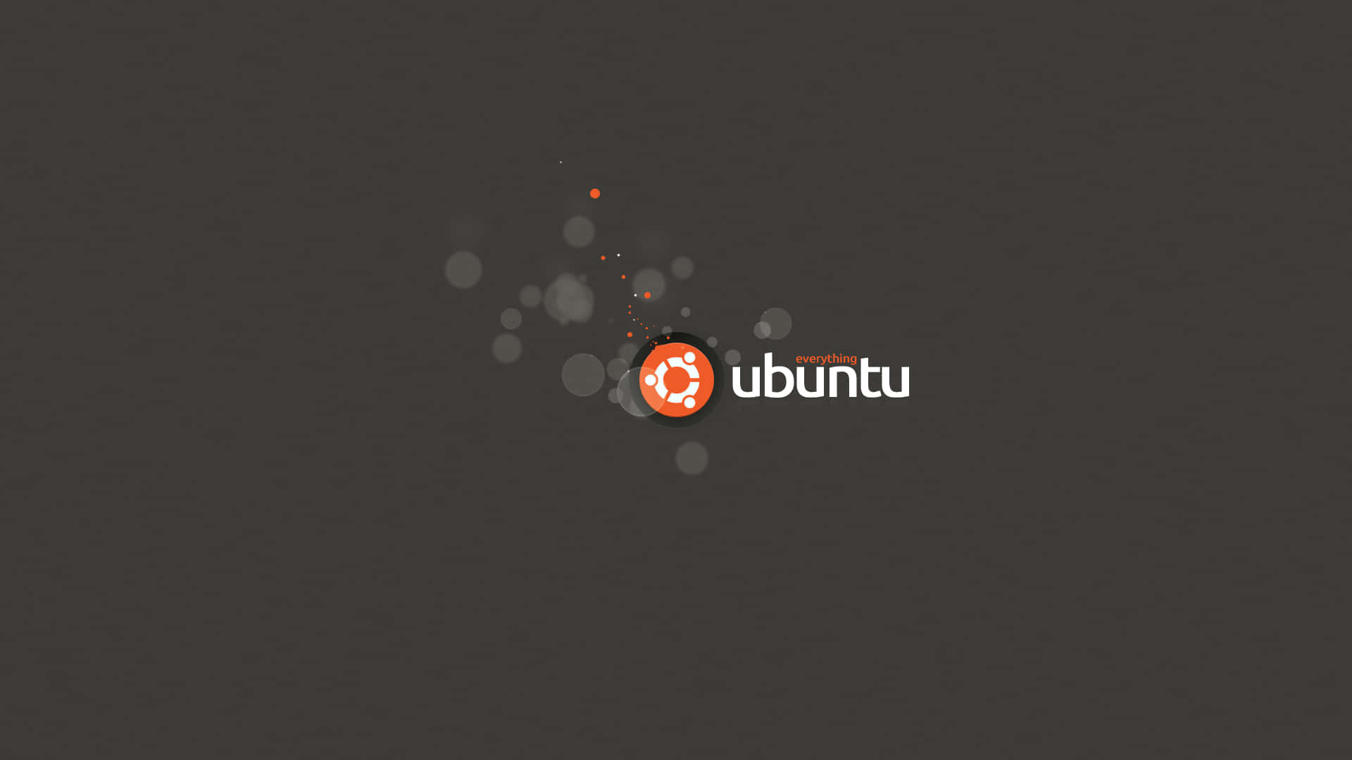 Ubuntu 標誌，橙色圓圈和白色文字在深灰色背景上，帶有浮動的圓圈。