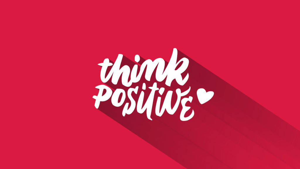 正面思考字體藝術 壁紙 — 粗體白色手寫文字寫著「think positive」，帶有心形圖標，在鮮紅色背景上投下長長的陰影。