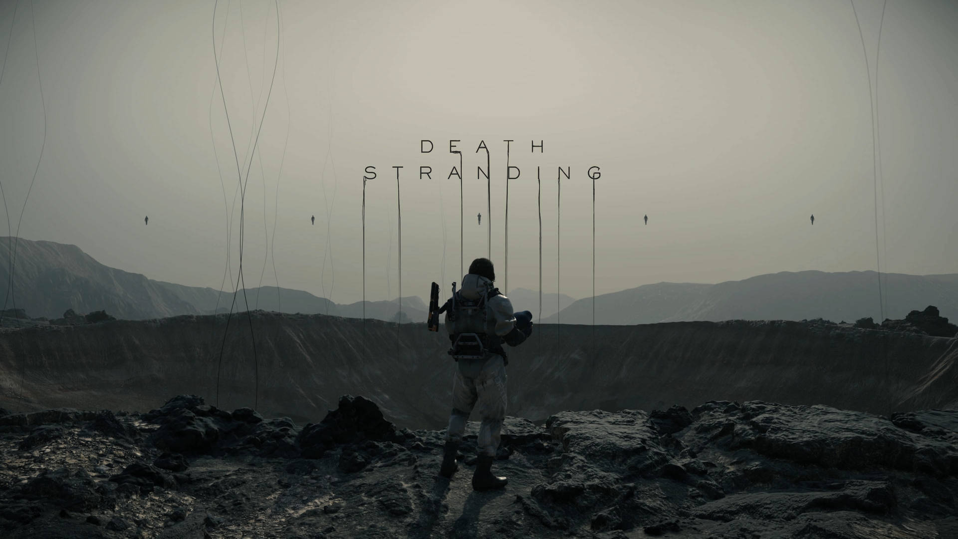 一個孤獨的身影背著背包，站在荒涼的風景中，面對著Death Stranding的標題。