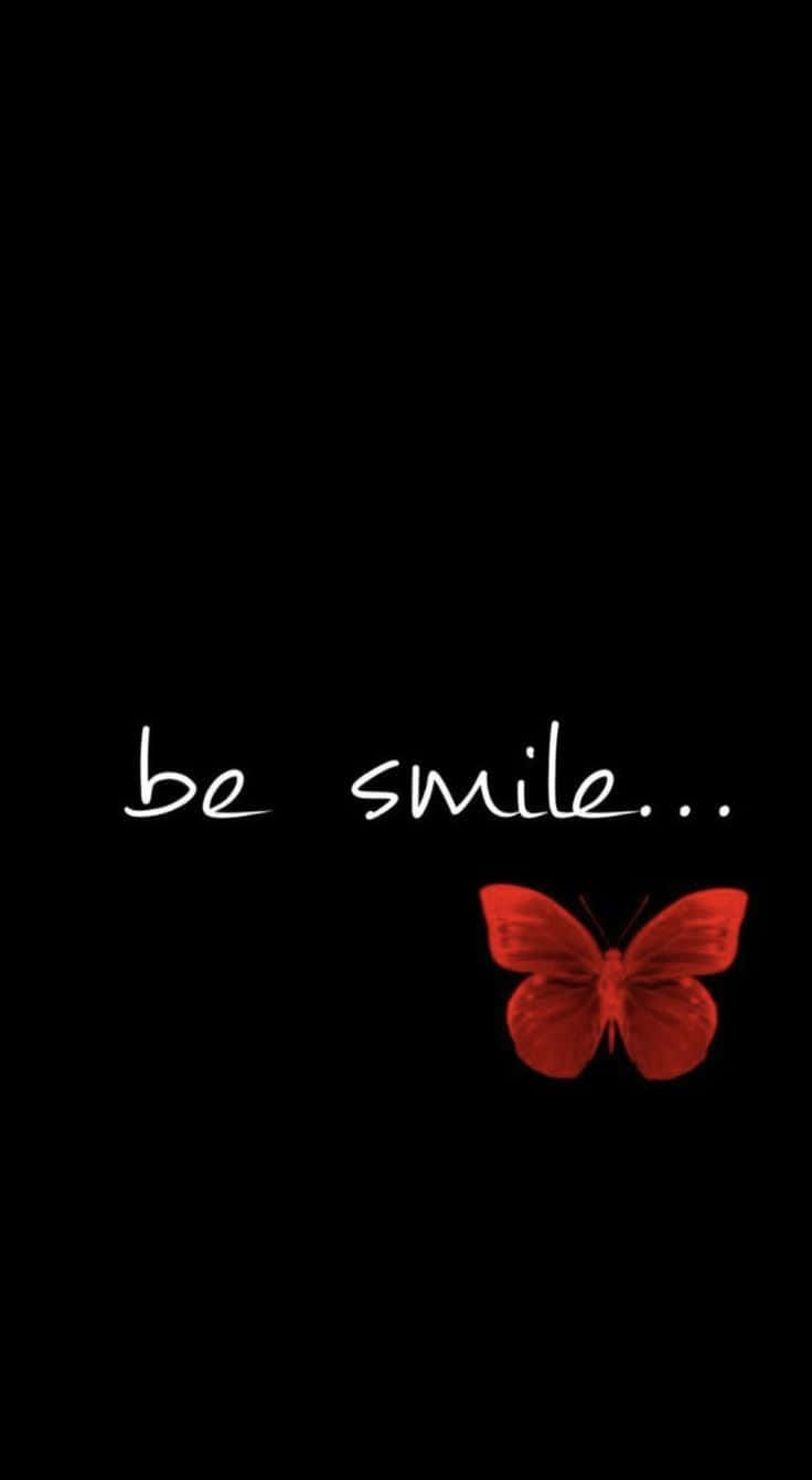 紅色蝴蝶與文字「be smile」在黑色背景上