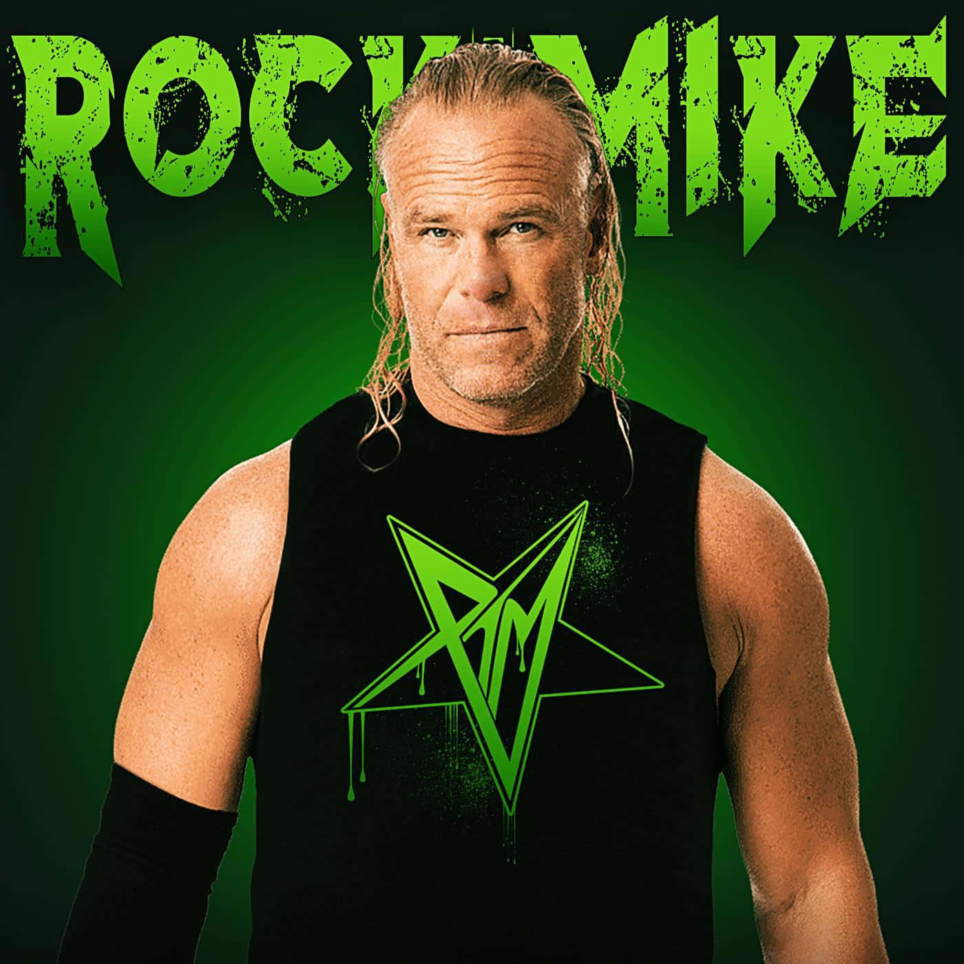 比利·岡恩為Rock the Mike宣傳藝術照 壁紙 — 一個肌肉發達、長著金色長髮的男人，穿著一件黑色無袖襯衫，上面有一個滴落的綠色星星標誌，背景是純綠色。