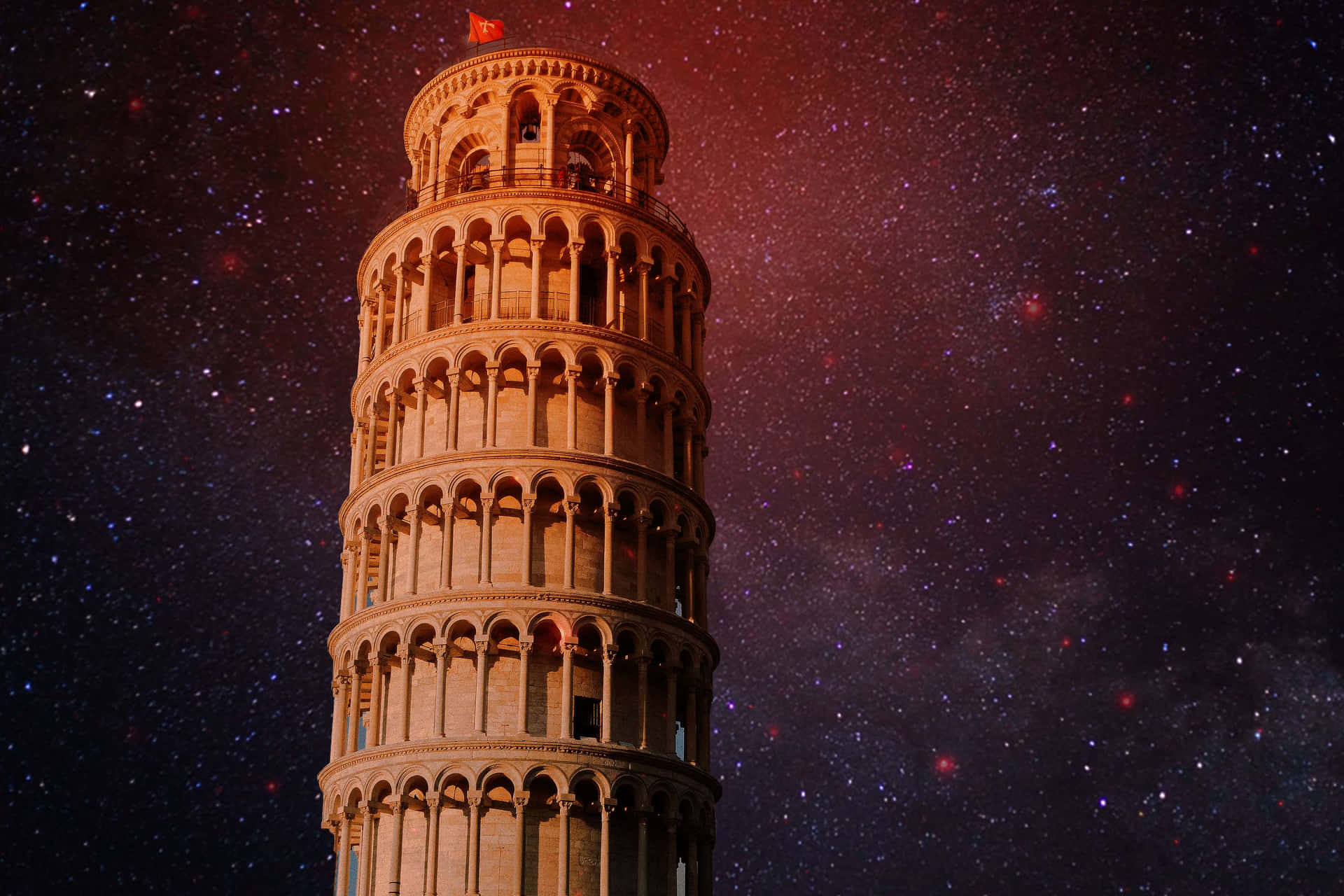 比薩斜塔在紅色和紫色色調的星空下亮起。