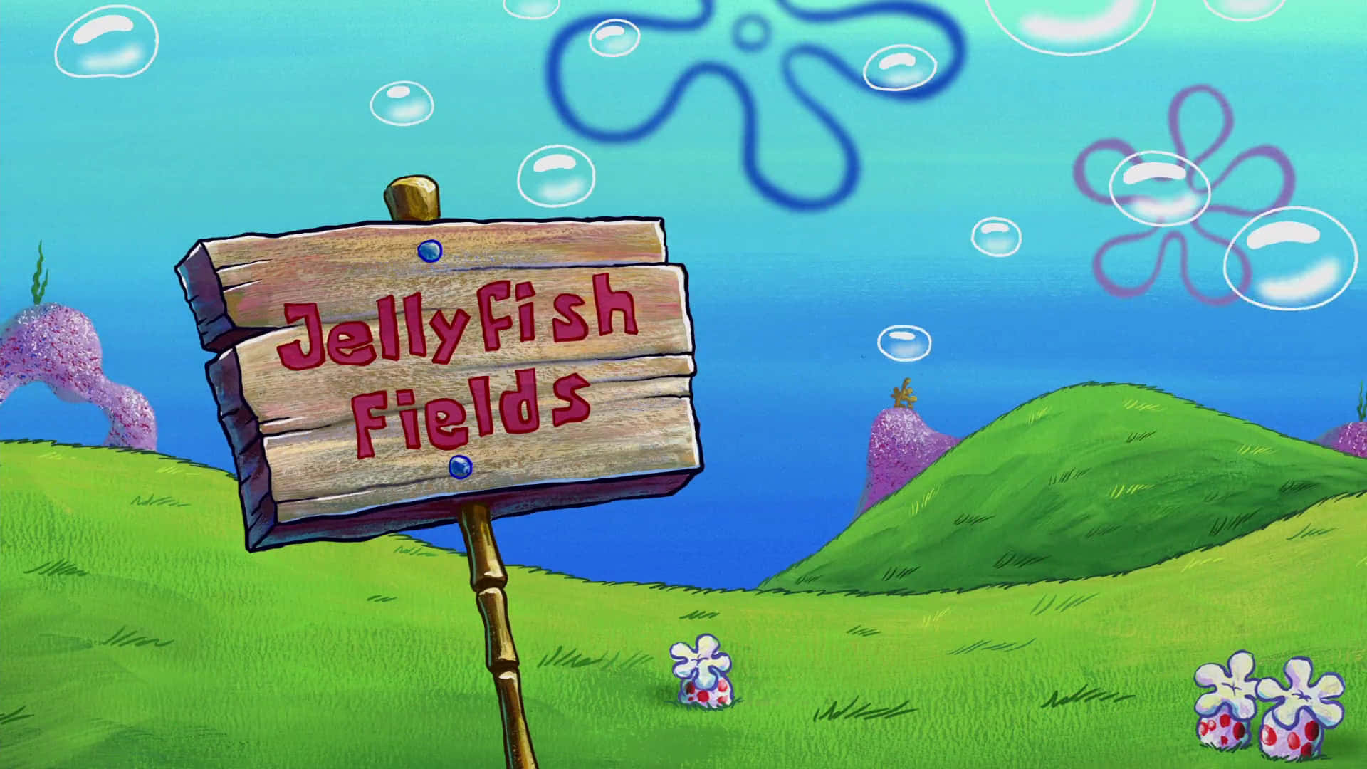 水下寫著Jellyfish Fields的牌子，有綠色山丘和氣泡
