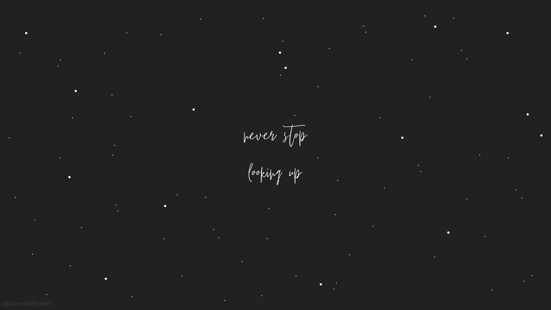 黑暗的星空，白色草書文字寫著「never stop looking up」。