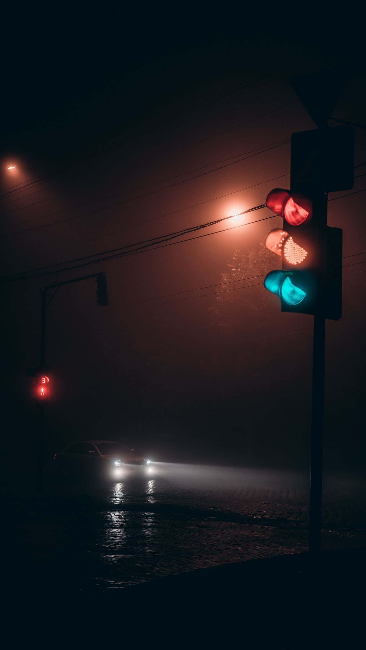 Dark Road 桌布 壁紙 — 汽車頭燈穿透霧氣，交通燈在黑暗雨夜的街道上閃爍著紅、琥珀和綠光。