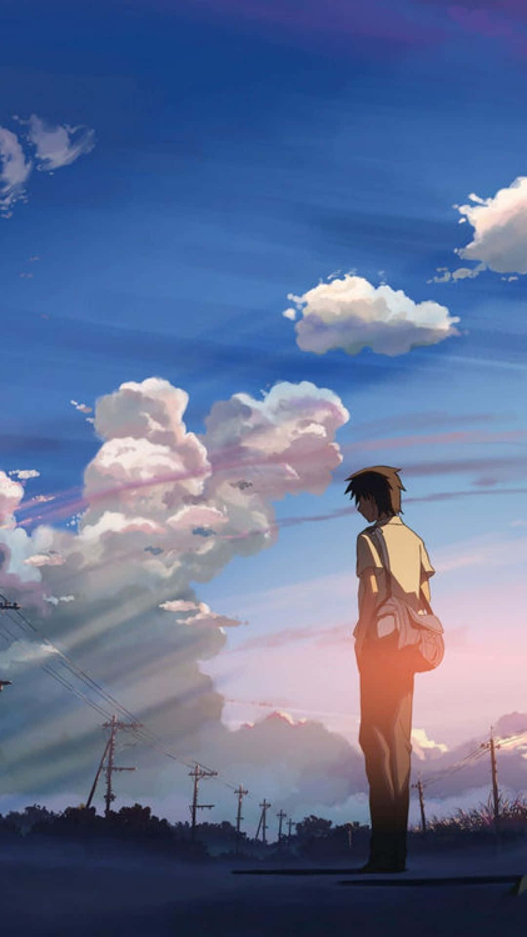 動漫男孩獨自站在日落時分的路上觀看色彩繽紛的雲彩。