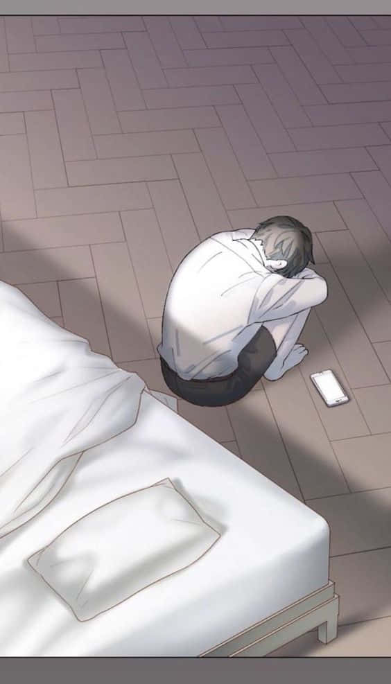 動漫男孩坐在床邊的地板上，看起來沮喪，手機在附近。