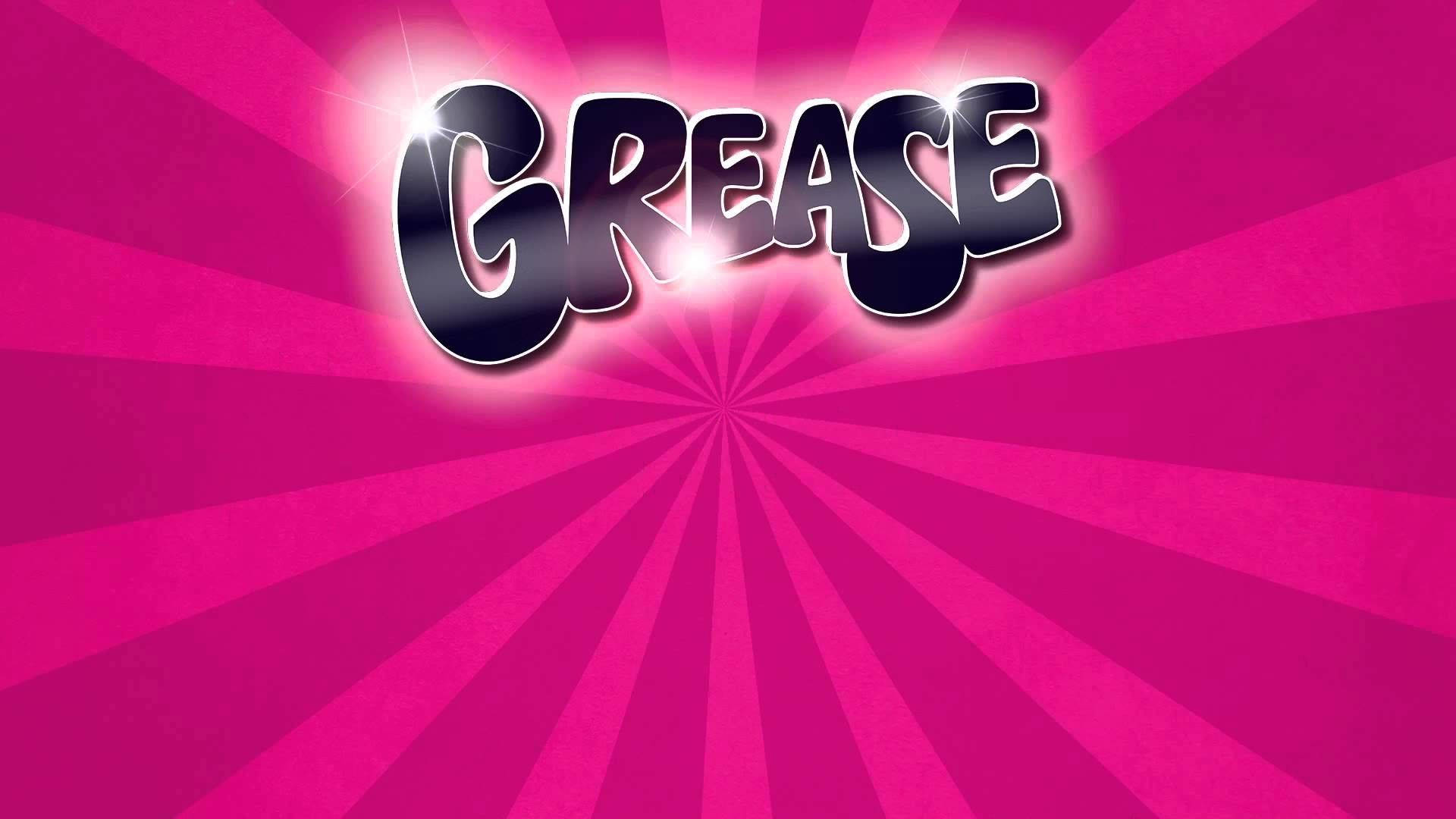 《油脂》七十年代風格字體 壁紙 — 粗體「GREASE」標誌在充滿活力的粉紅色放射狀爆發背景上閃爍著光芒。